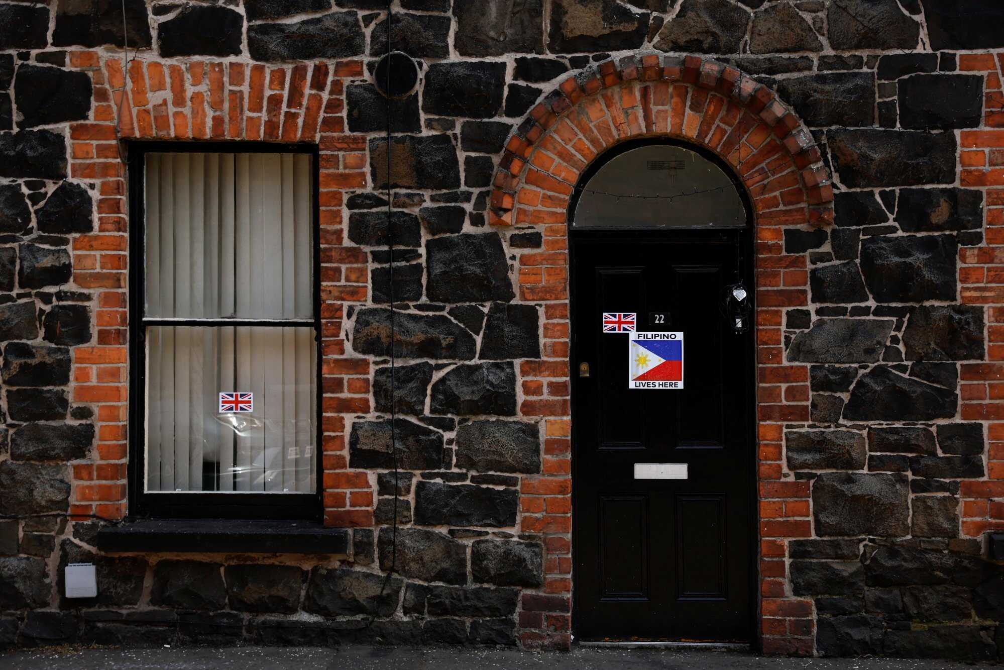 A view shows stickers with United Kingdom and Philippines’ flags placed on a house, following riots in Ballymena, Northern Ireland, June 11, 2025. REUTERS/Clodagh Kilcoyne
