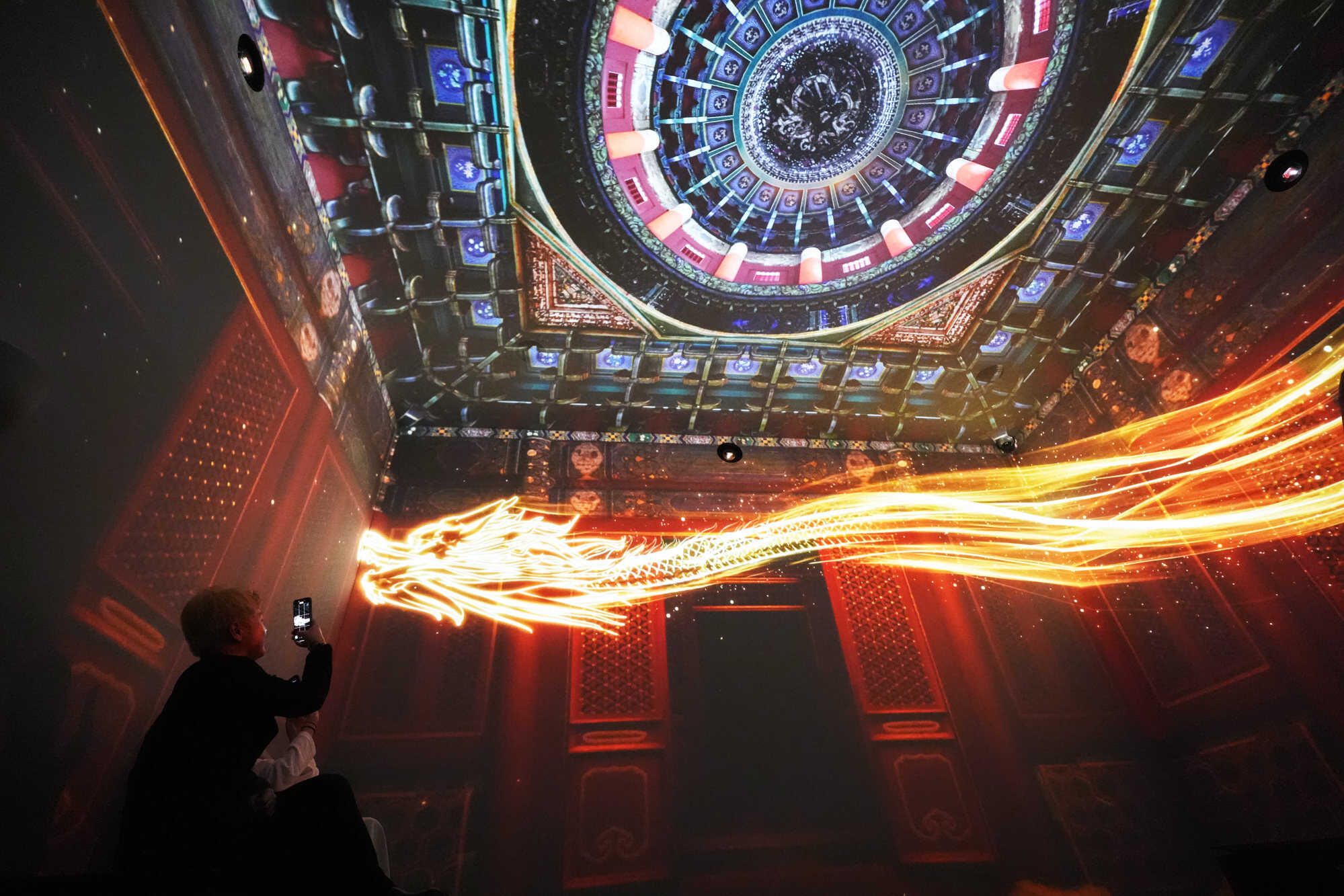 A bright projection of a dragon floats in the air at the section called Ceiling Decorations. Photo: Eugene Lee