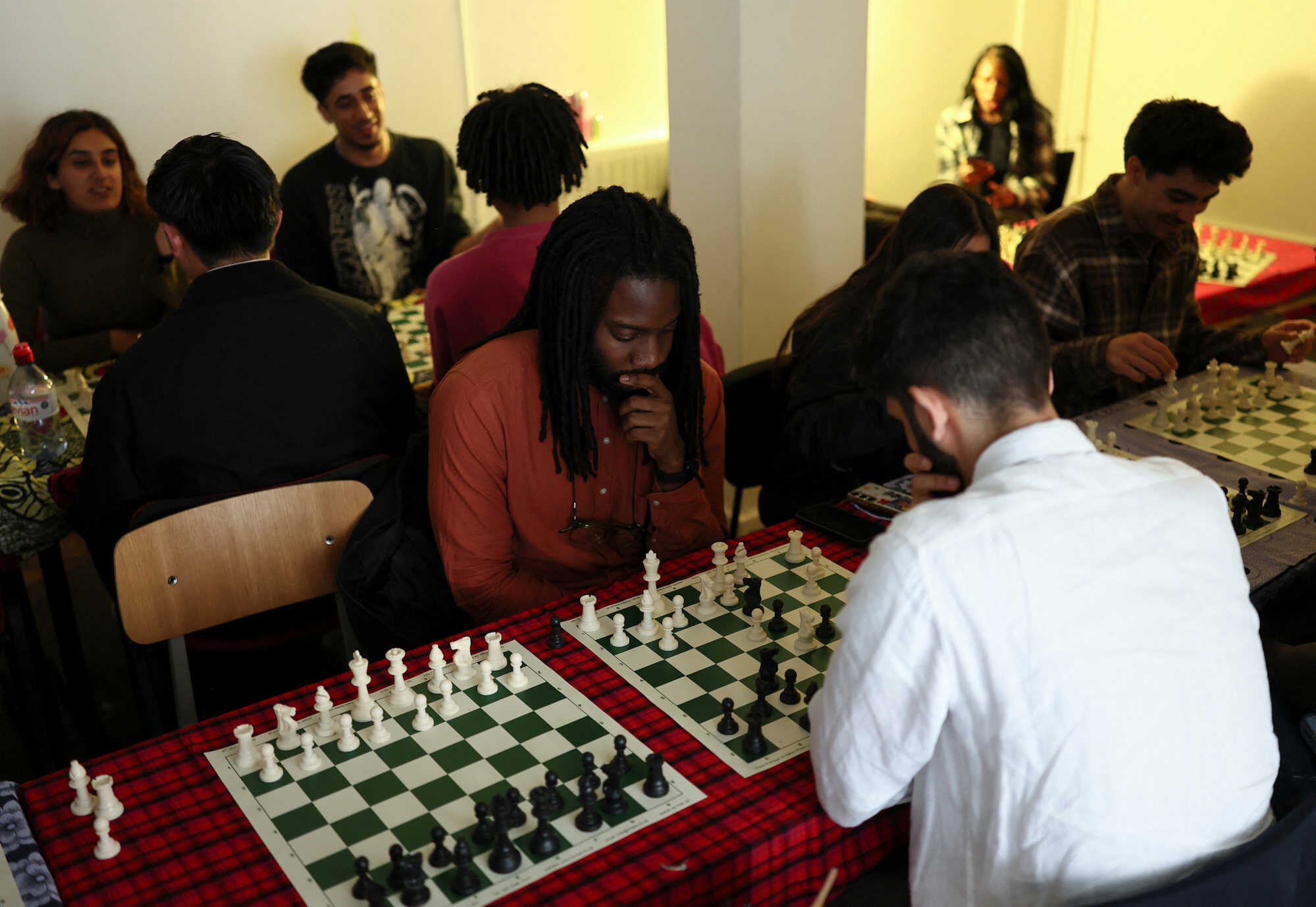 Young adults play chess at Knight Club, a diverse chess club growing to almost a thousand members within a year, based in London, UK. Photo: Reuters