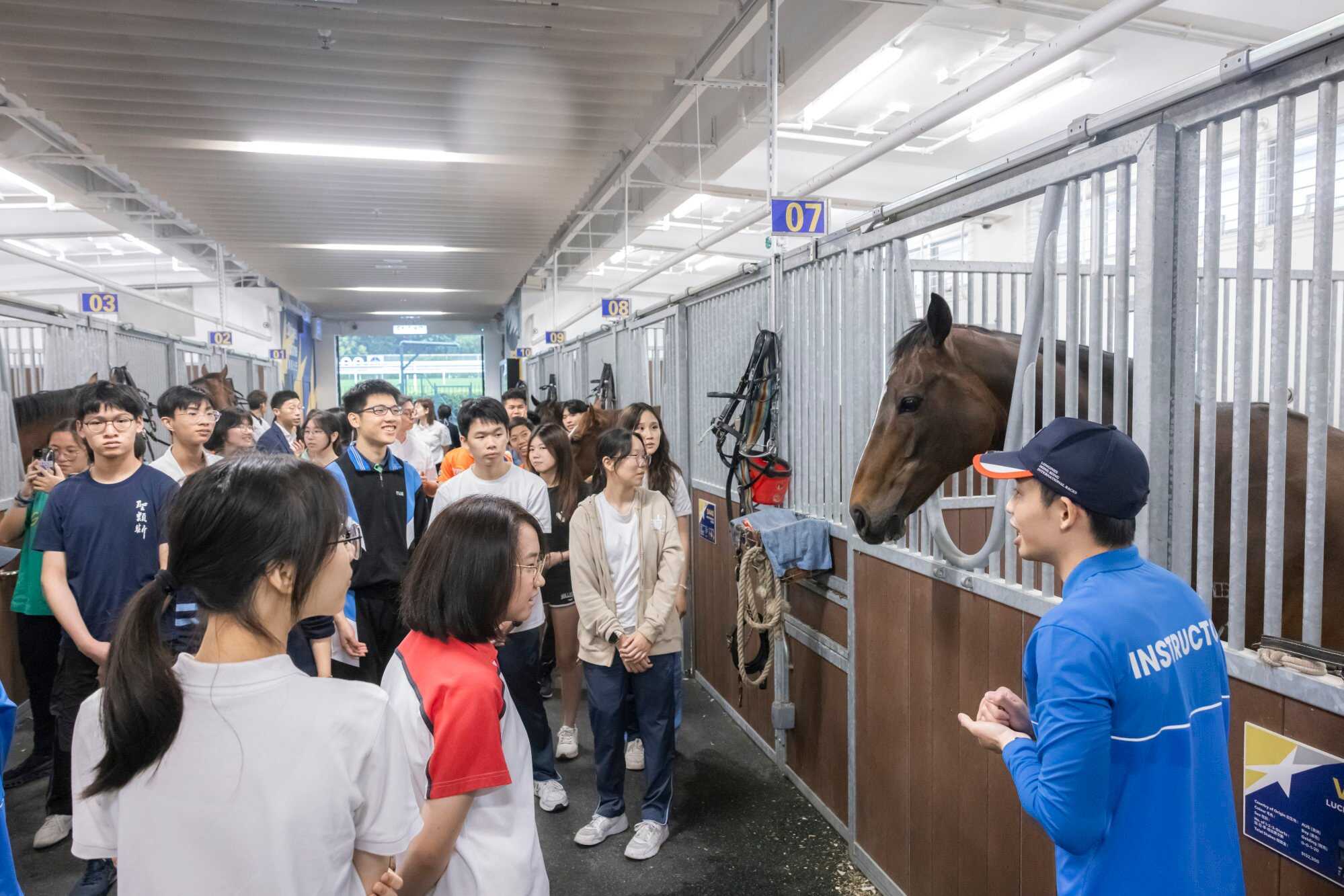 SOTY nominees listen attentively to senior instructor Jack Wong in the stable.