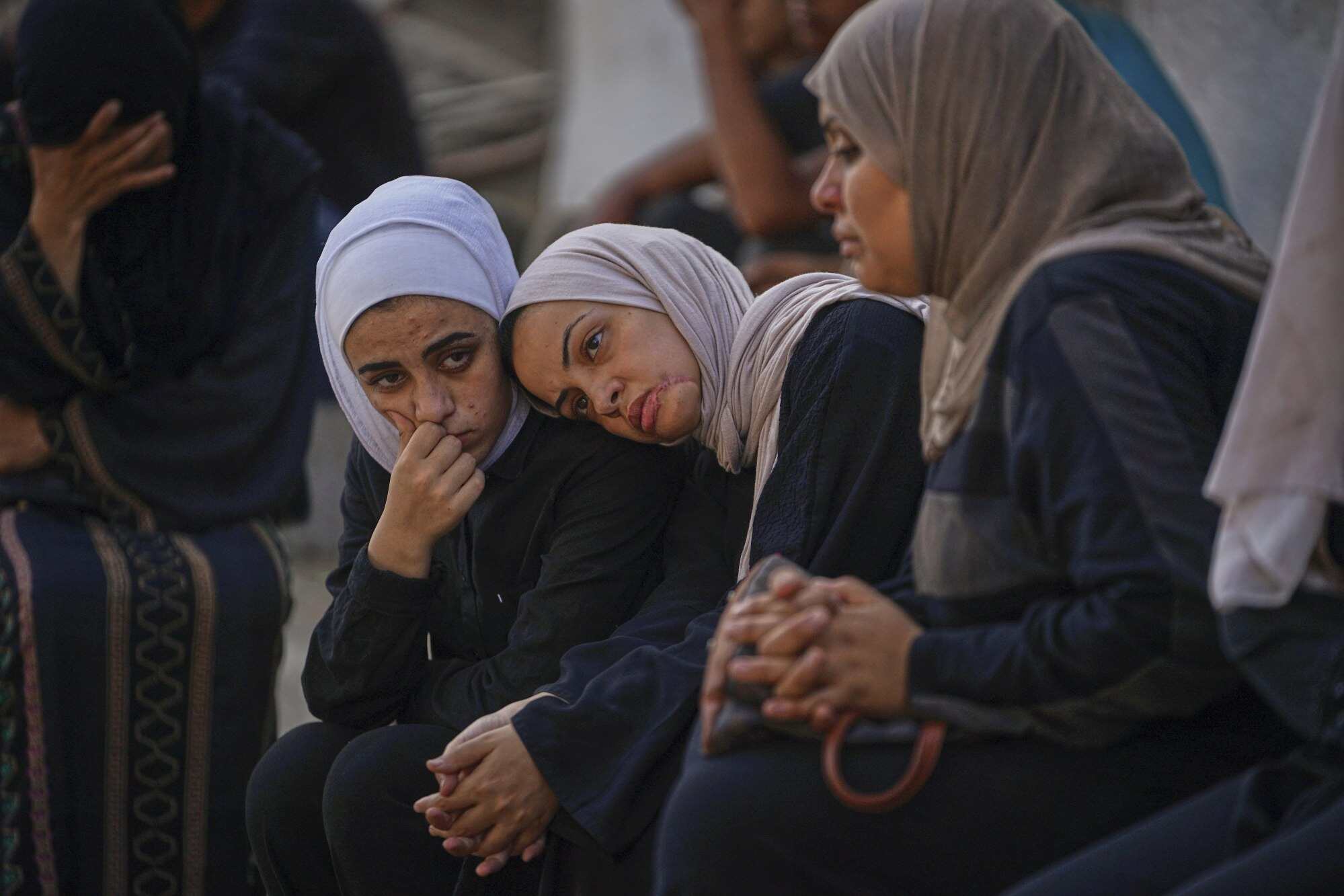 Relatives of Palestinians killed in Israeli strikes wait for their burials in Gaza. Photo: AP