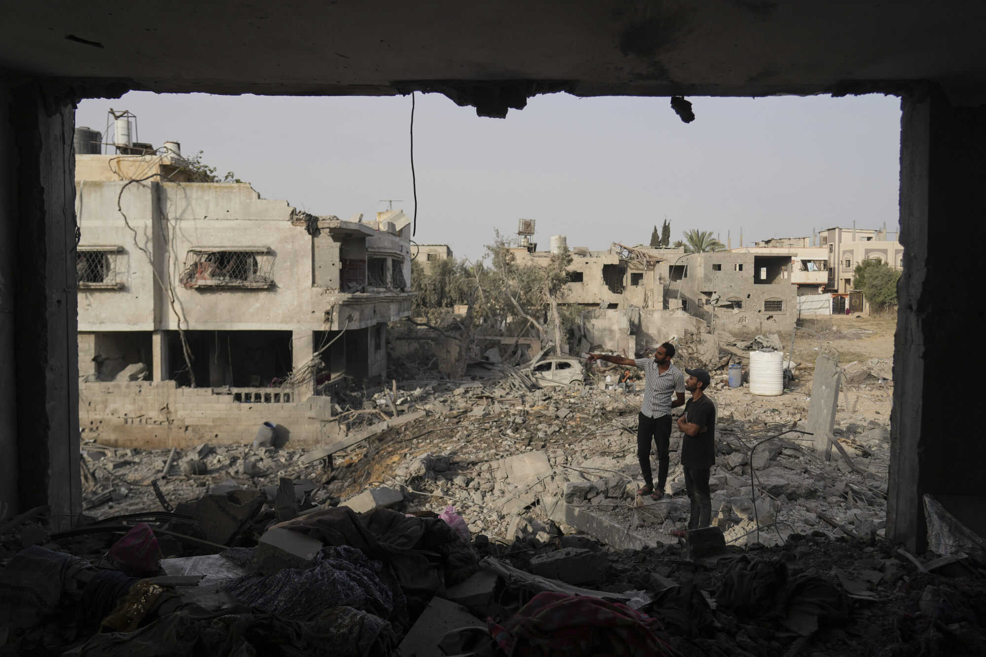 Palestinians inspect the rubble of the Al-Aimawi family’s home, destroyed by Israeli air strikes in Al-Zawaideh, Gaza Strip. The strikes on Tuesday, July 1 came a day after Israeli forces killed 11 Palestinians waiting for aid, according to the region’s civil defence agency. Photo: AP