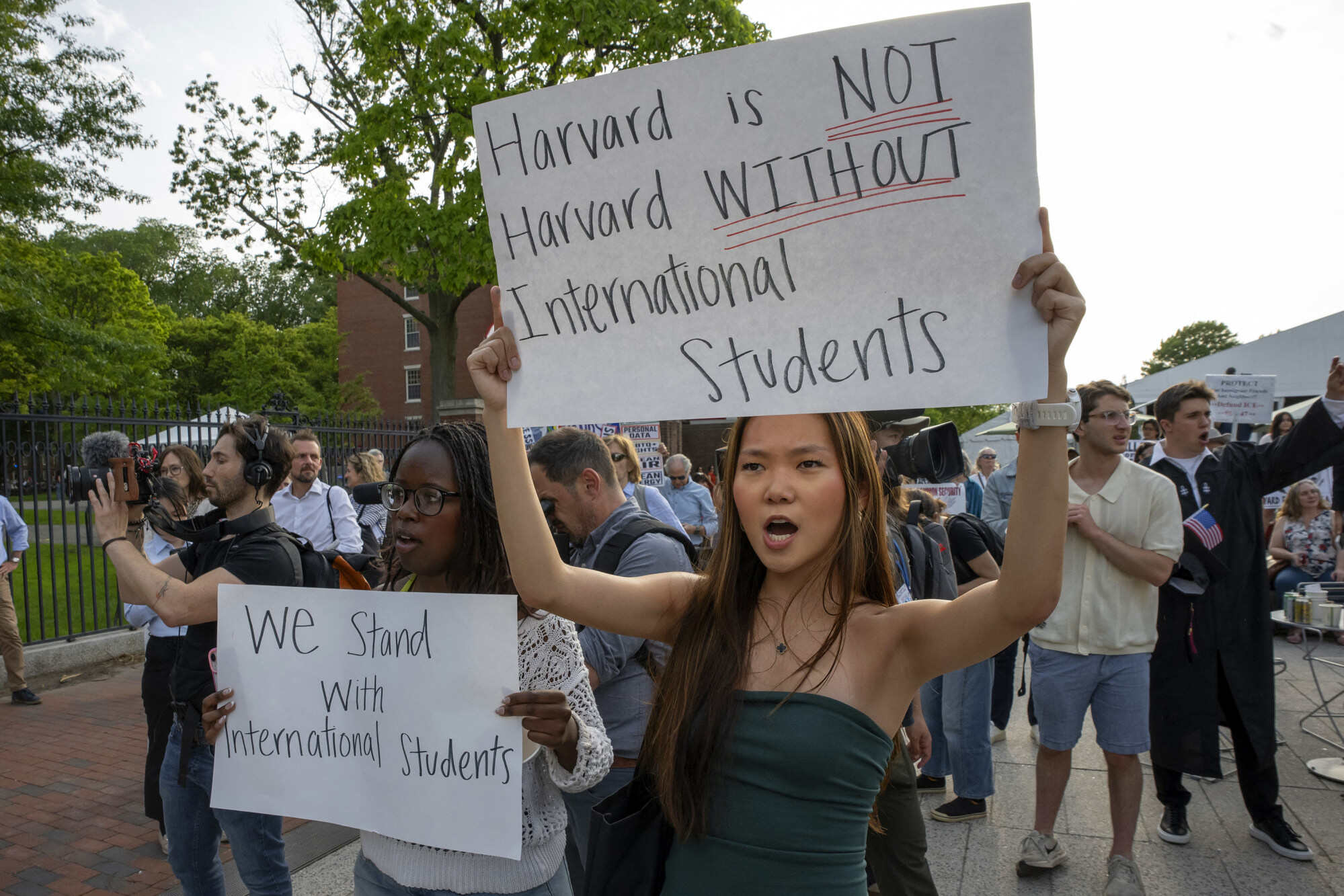 People hold up signs during a rally in support of international students at the Harvard University campus in Boston, Massachusetts, United States in May. Photo: AFP
