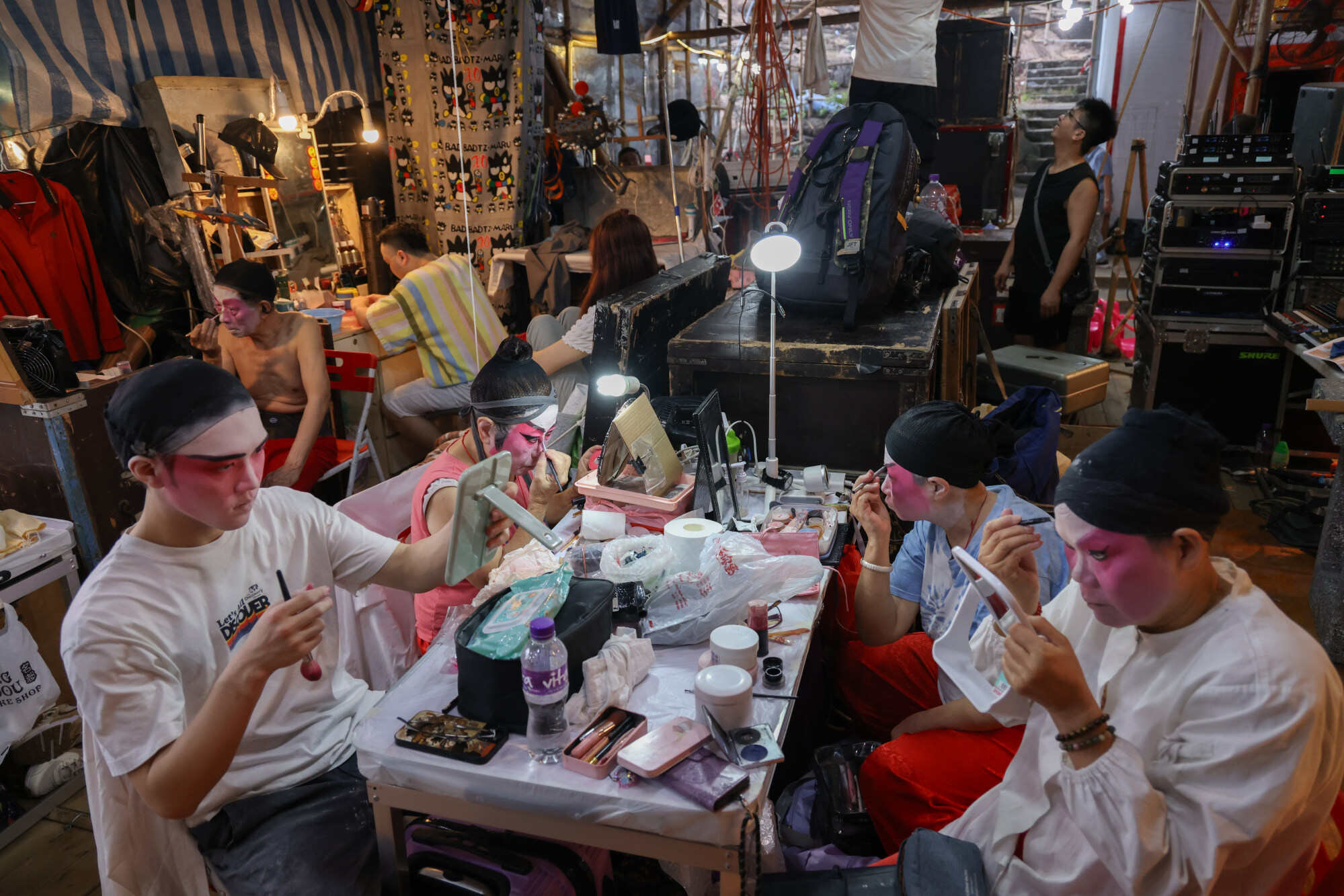 Opera performers apply their stage make-up at the bamboo theatre on Po Toi Island. Photo: Eugene Lee