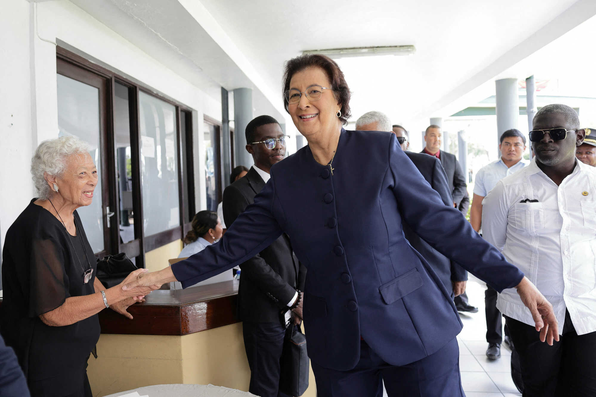 Suriname’s then-opposition leader Jennifer Geerlings-Simons greets a woman after the National Assembly election in Paramaribo on July 6, 2025. Photo: AFP