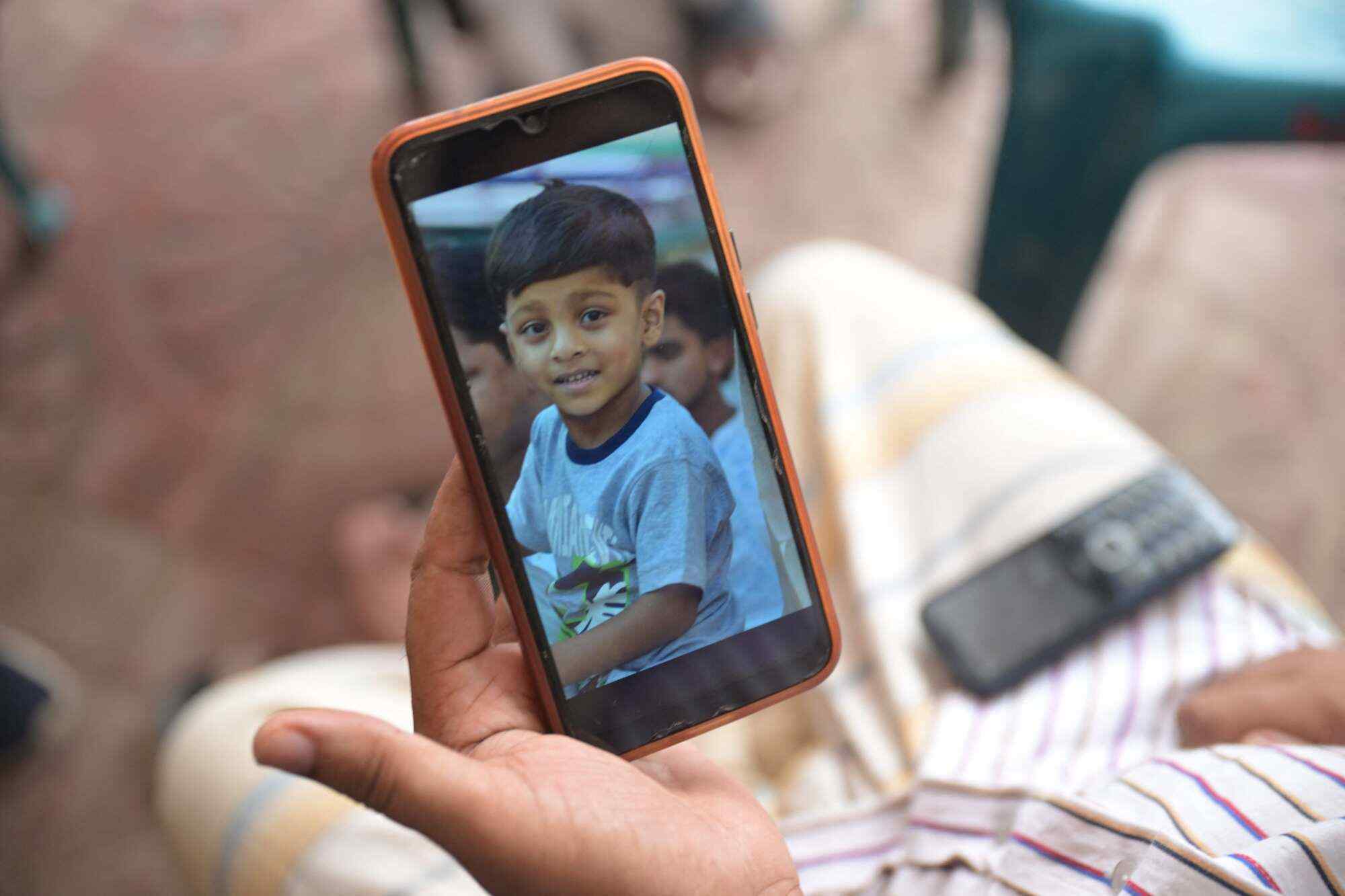 Mohammed Russell shows a cellphone photo of his nephew, Md Ashikur Rahman Umair, who died when a military training jet crashed into an educational institution in Dhaka on July 23, 2025. Photo: AFP