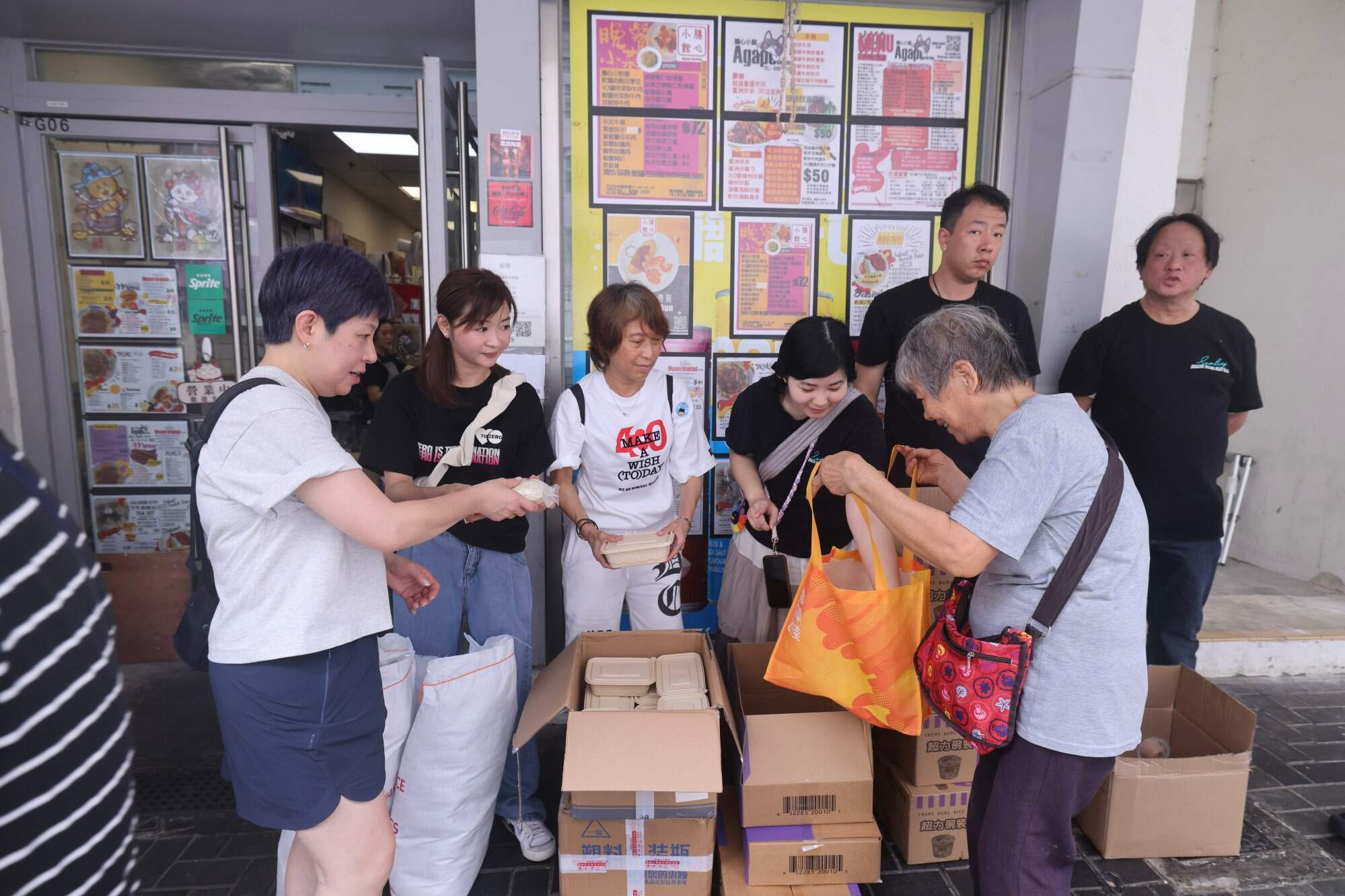 Social enterprise restaurant Agape Garden in Shek Kip Mei collaborated with fan clubs of singer Keung To to give free meals and food to elderly people in the community. Photo: Nora Tam