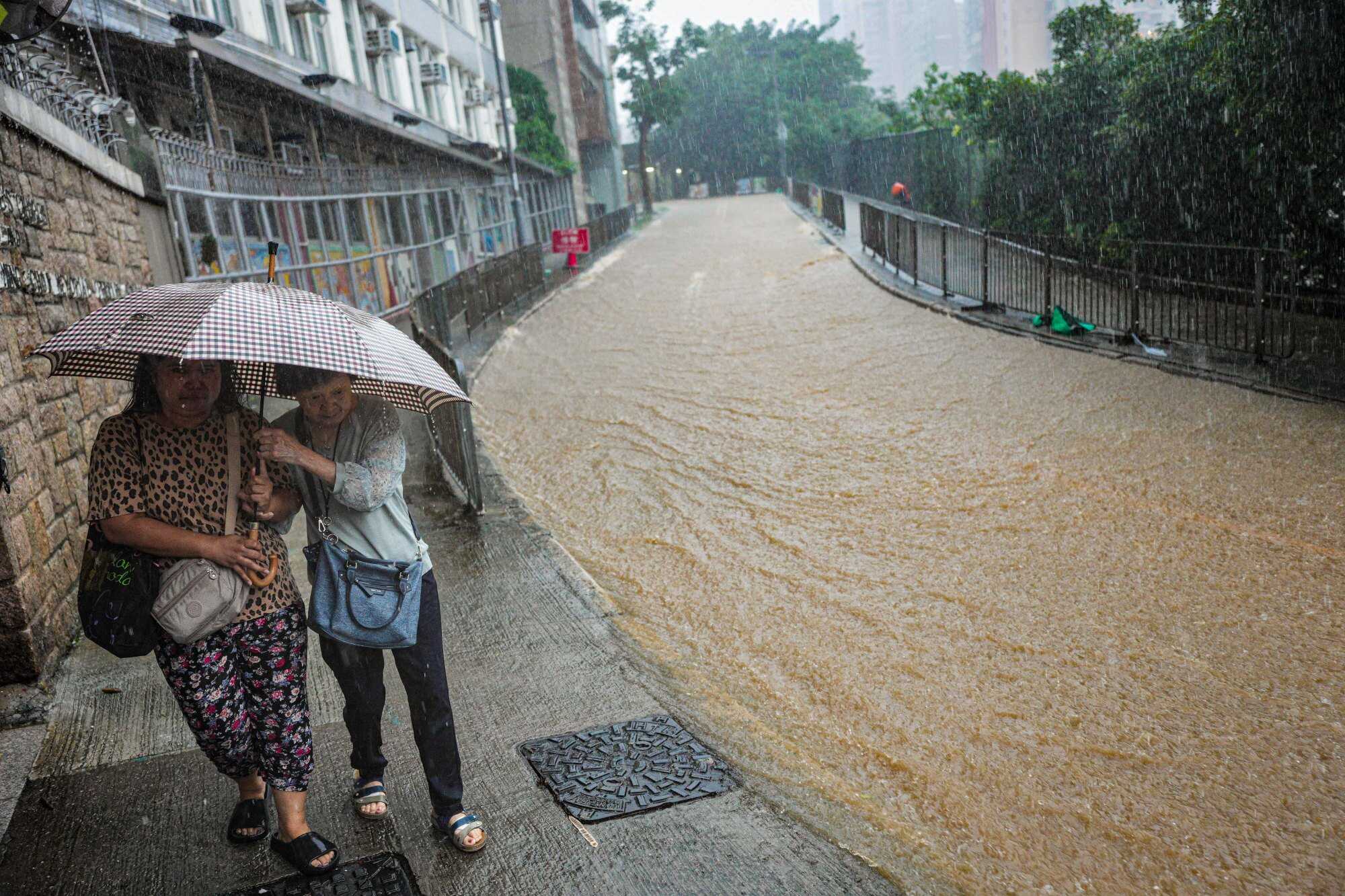 Flooding seen on Ka Wai Man road in Kennedy Town. The warning is expected to remain in force until 3pm. Photo: Eugene Lee