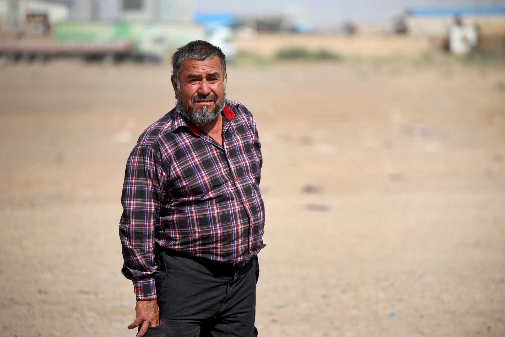 Rahim Uzbek, 59, an Afghan national who was deported from Iran, stands outside a camp for returning migrants near the Islam Qala border crossing in Herat province, Afghanistan. Photo: Reuters
