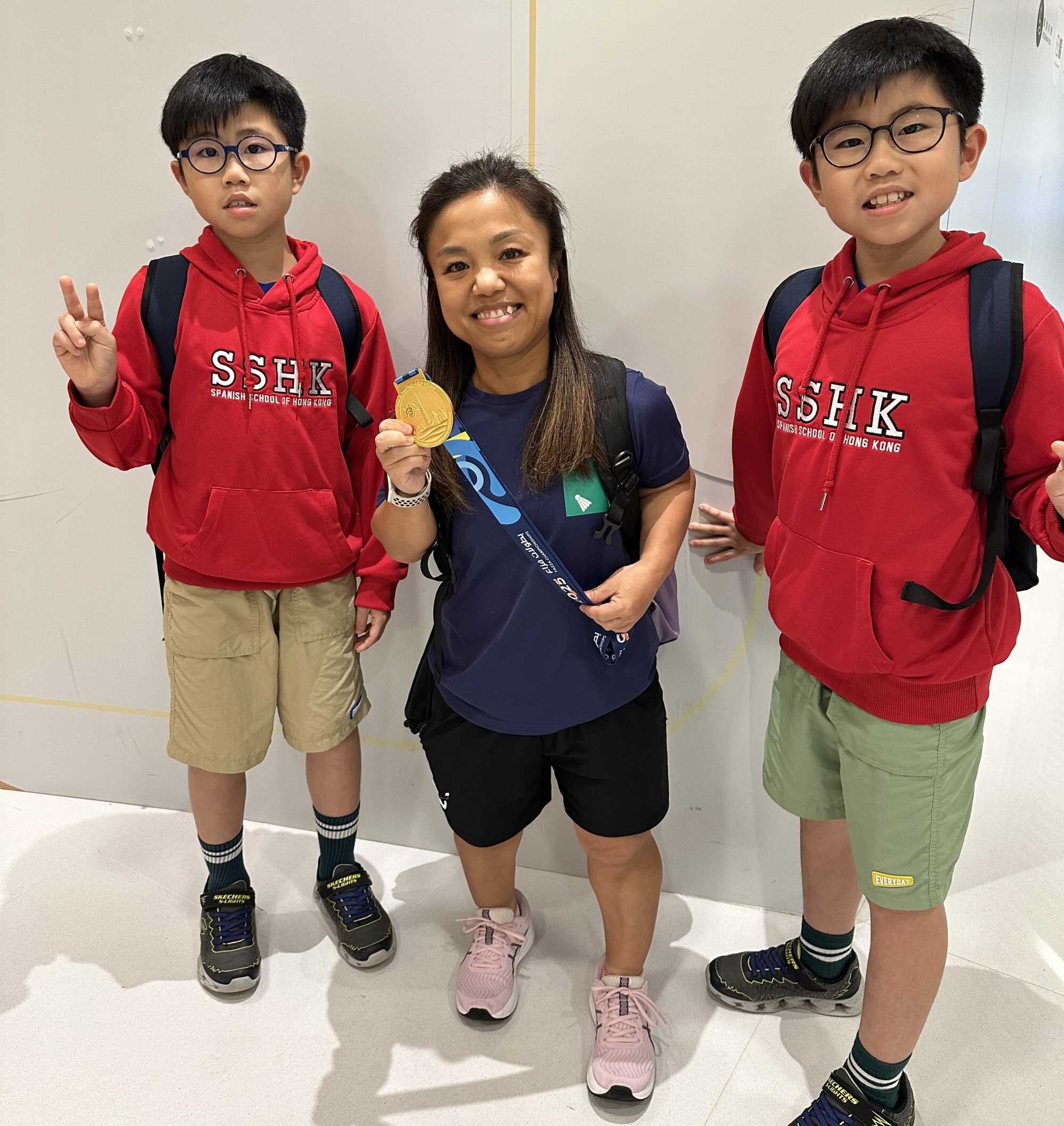 Thyler and Skyler Ng with Katy Choi Wing-kei, a para-athlete who represents Hong Kong in badminton.