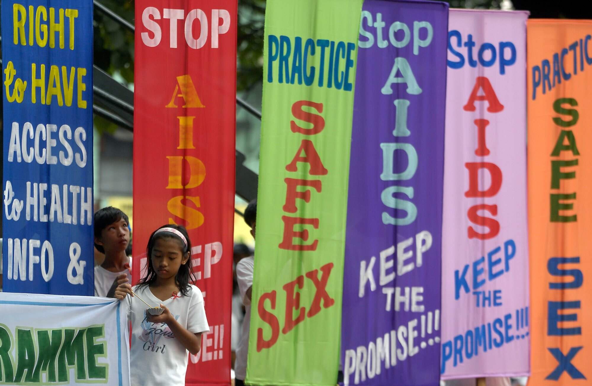 Children stand next to banners during a march to mark World Aids Day in Olongapo City, Zambales, northern Philippines on December 1, 2008. HIV cases in the Philippines have skyrocketed, going up by 550 per cent in 2024 from 2010. Photo: AFP