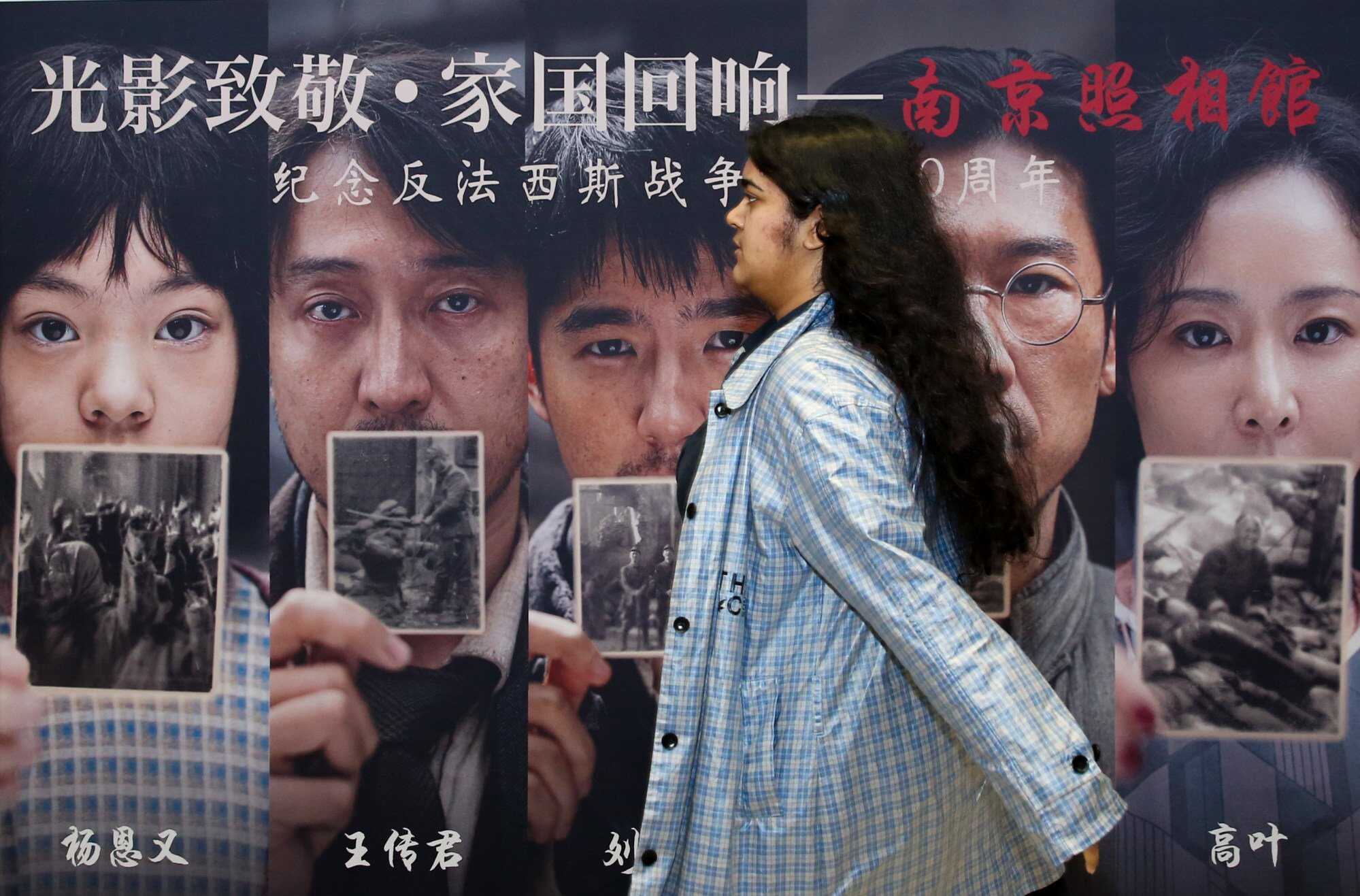 A woman walks past a poster of “Dead to Rights” at a cinema in Sydney, Australia. Photo: Xinhua