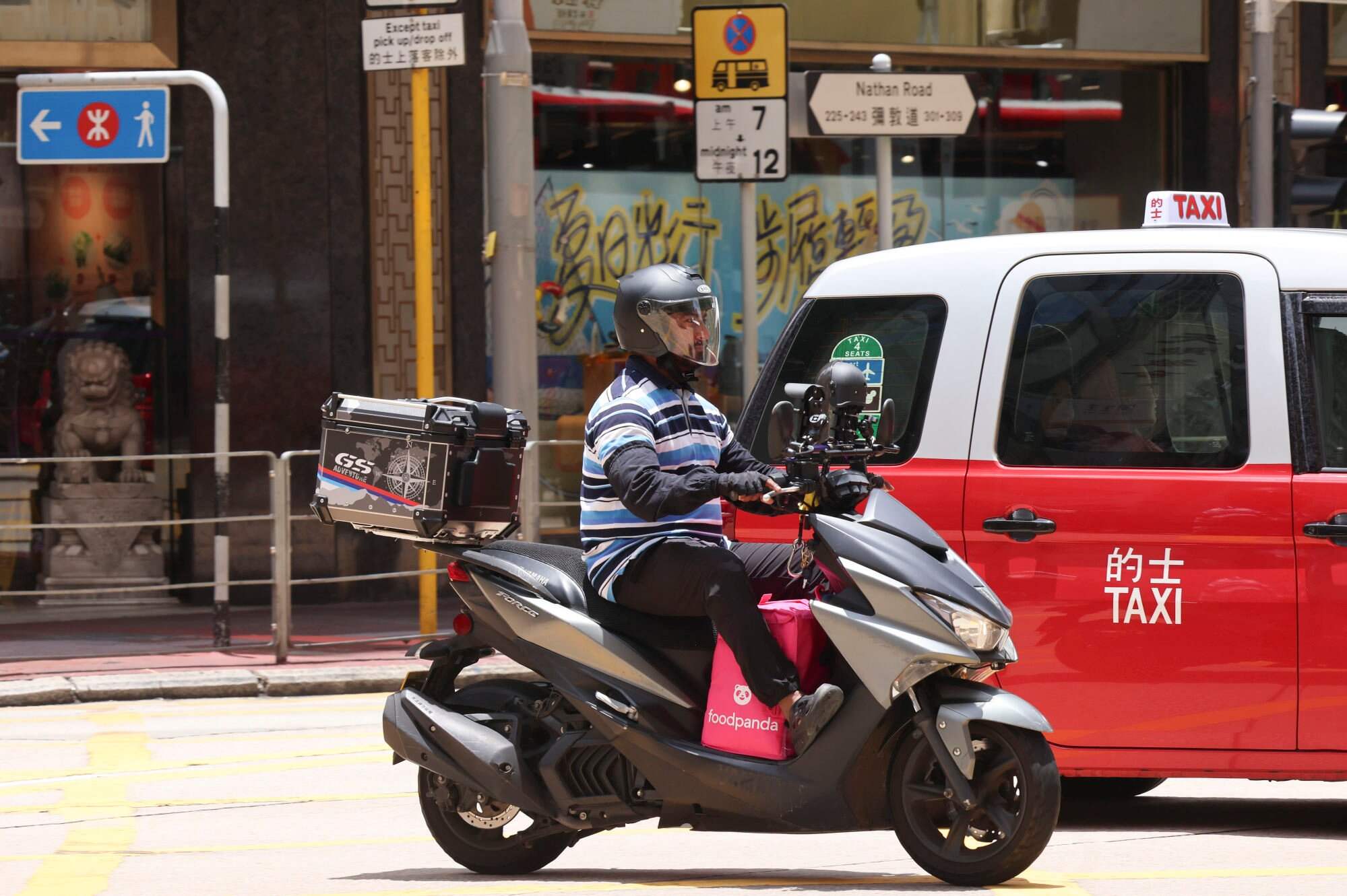 A motorcycle deliveryman on Nathan Road in Jordan. A 2022 study found that 89 per cent of surveyed food delivery workers in Hong Kong belonged to ethnic minority groups. Photo: Jelly Tse