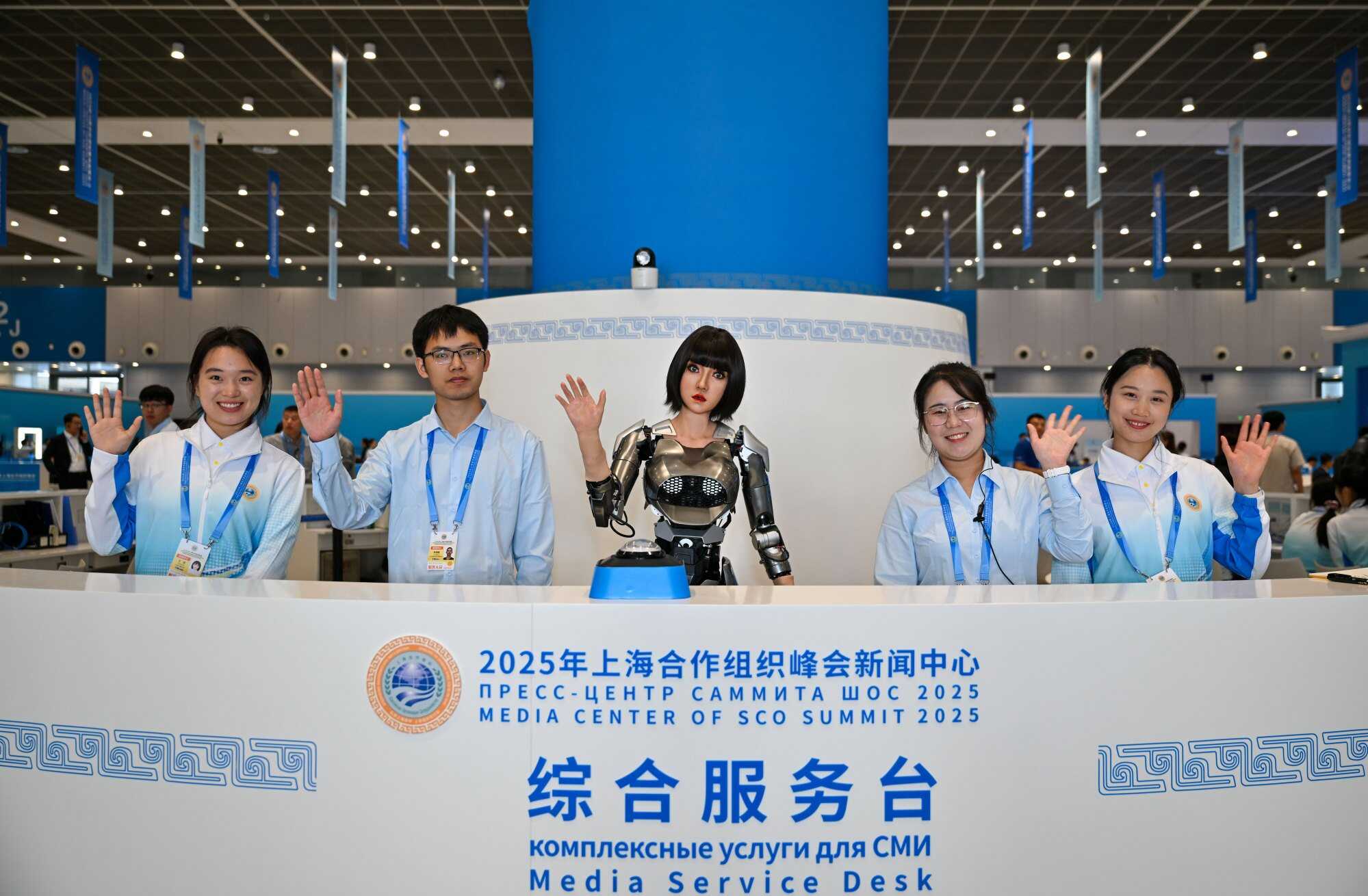 A humanoid robot (centre) welcomes journalists. Demand for “tech tourism” had grown sharply since the pandemic. Photo: Xinhua