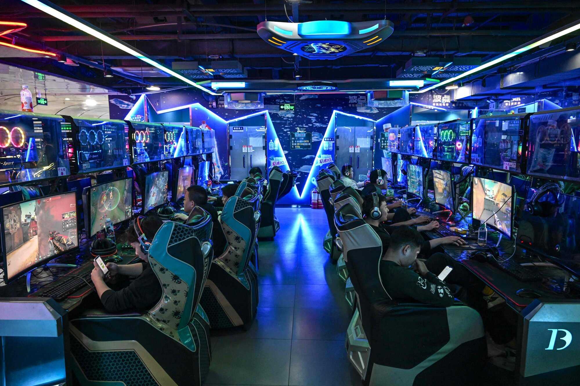 People play video games at an internet cafe in Beijing. Photo: AFP