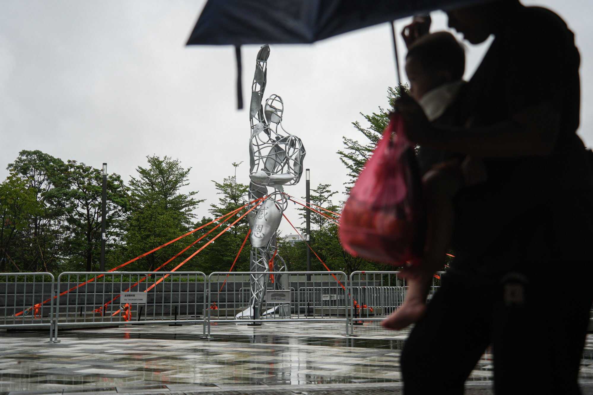 A sculpture in Kai Tak is anchored to the ground as a precaution on Sunday morning. Photo: Eugene Lee