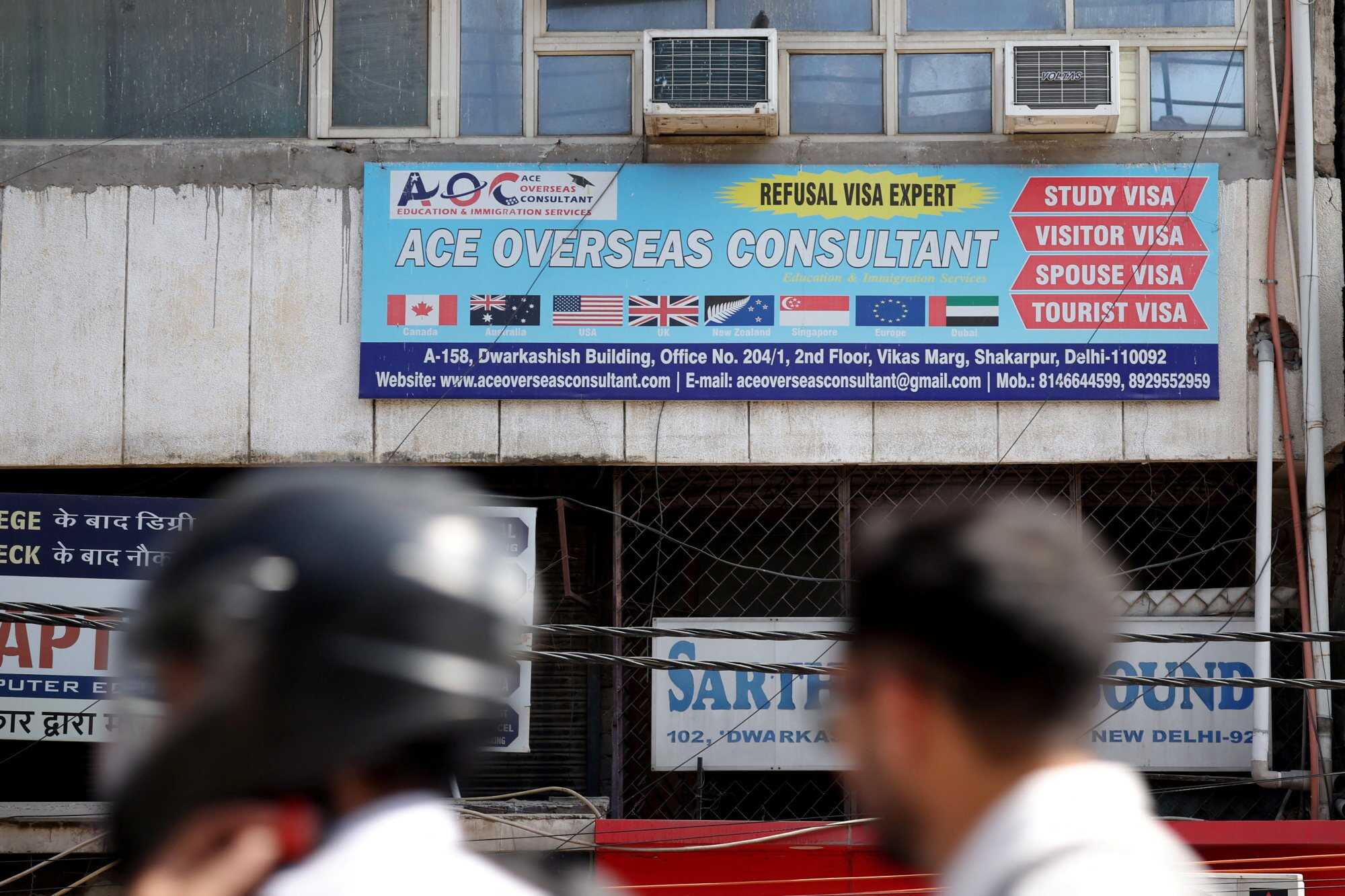 An advertisement for a visa consultancy office in New Delhi, India. Photo: Reuters