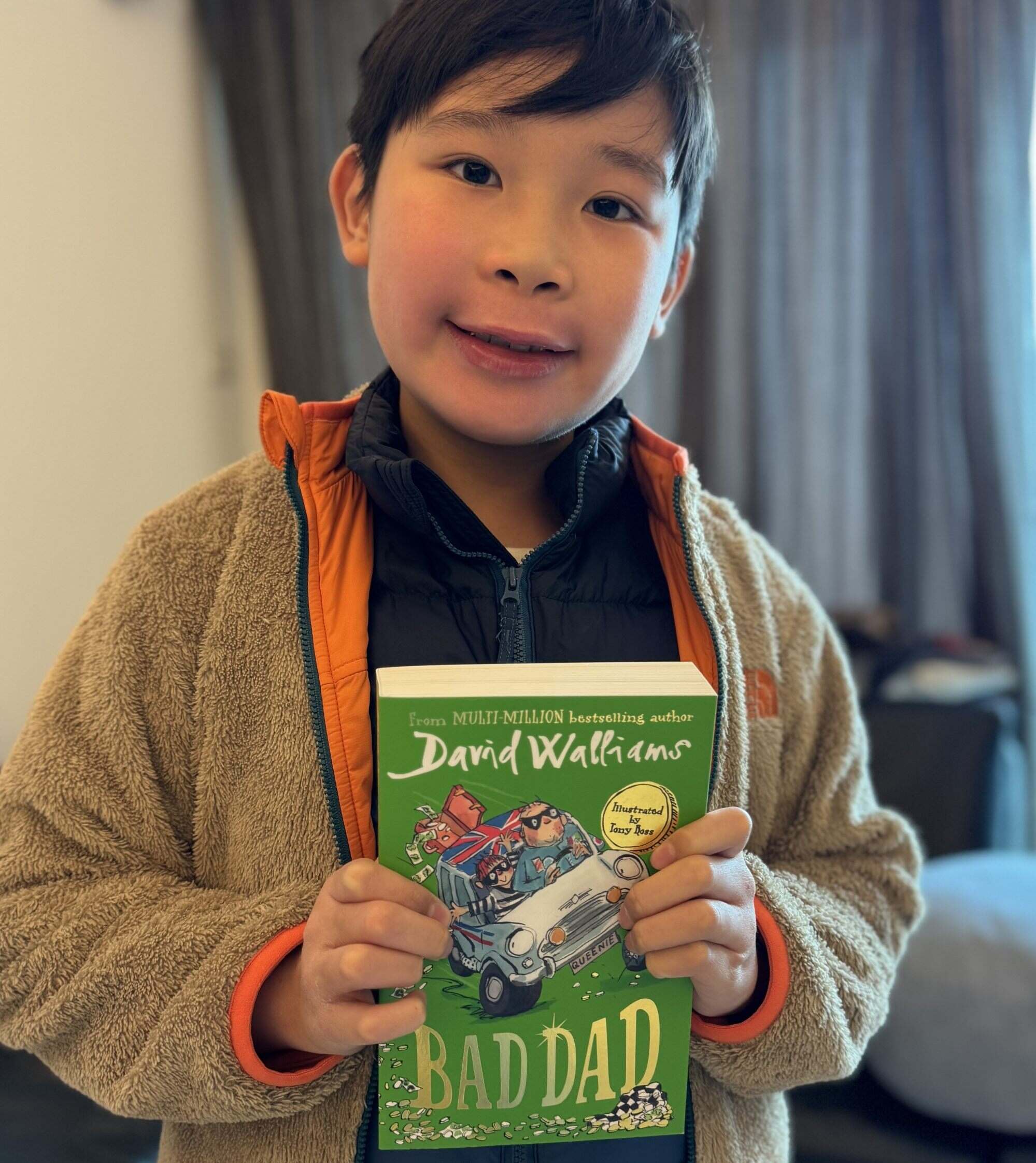 Isaac Chan holding a copy of ‘Bad Dad’ by David Walliams