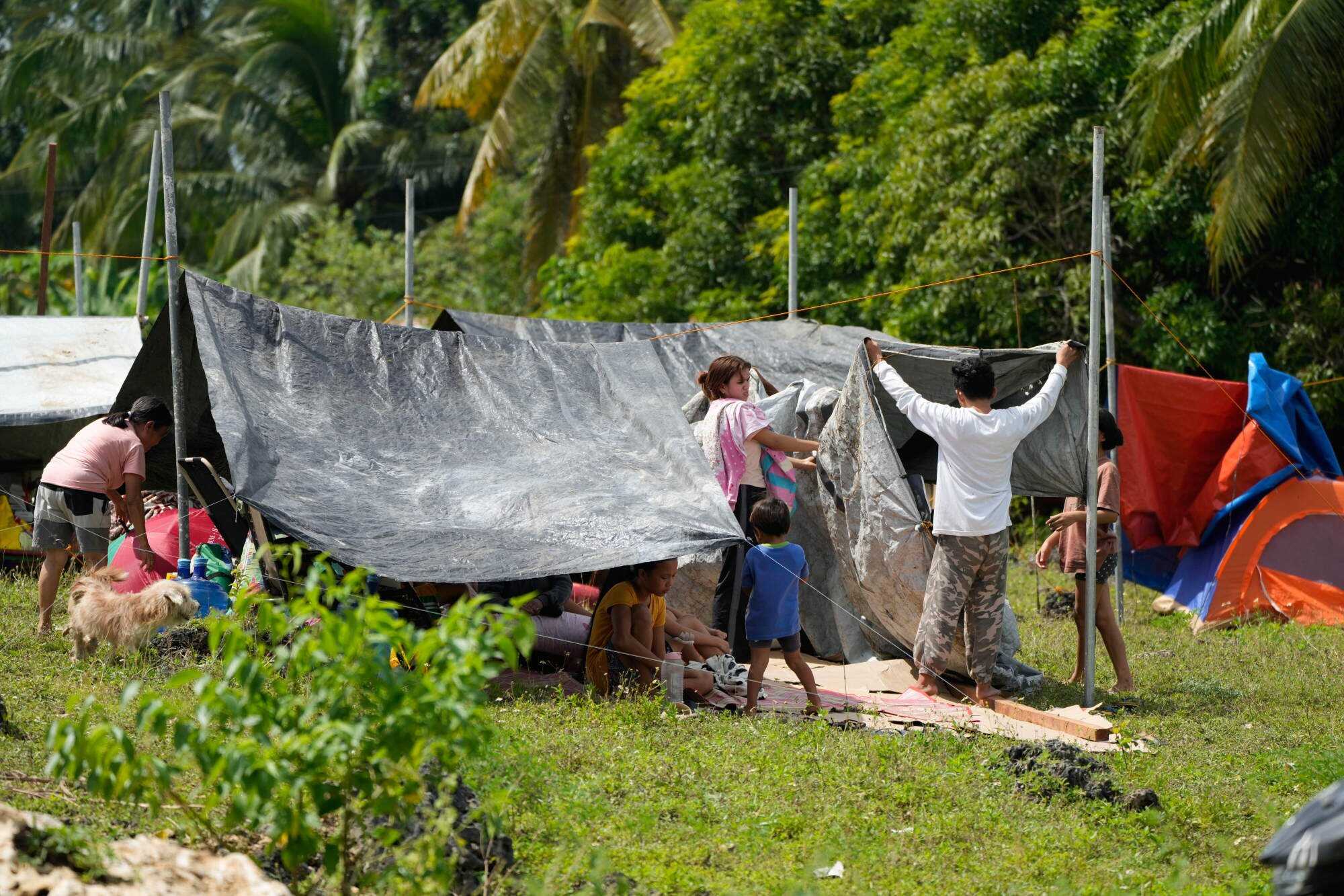 Survivors of Tuesday’s earthquake build tents in open spaces in San Remigio. Photo: AP
