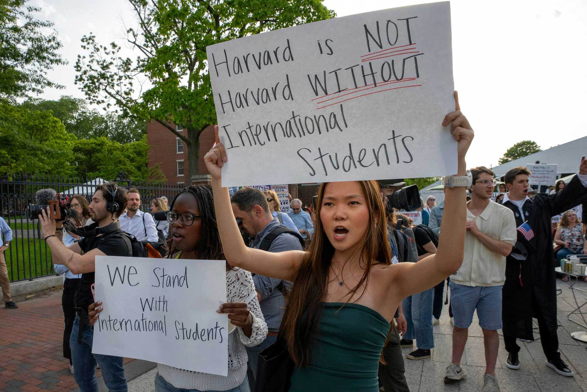 People hold up signs during the “Harvard Students for Freedom” rally in support of international students. Photo: AFP
