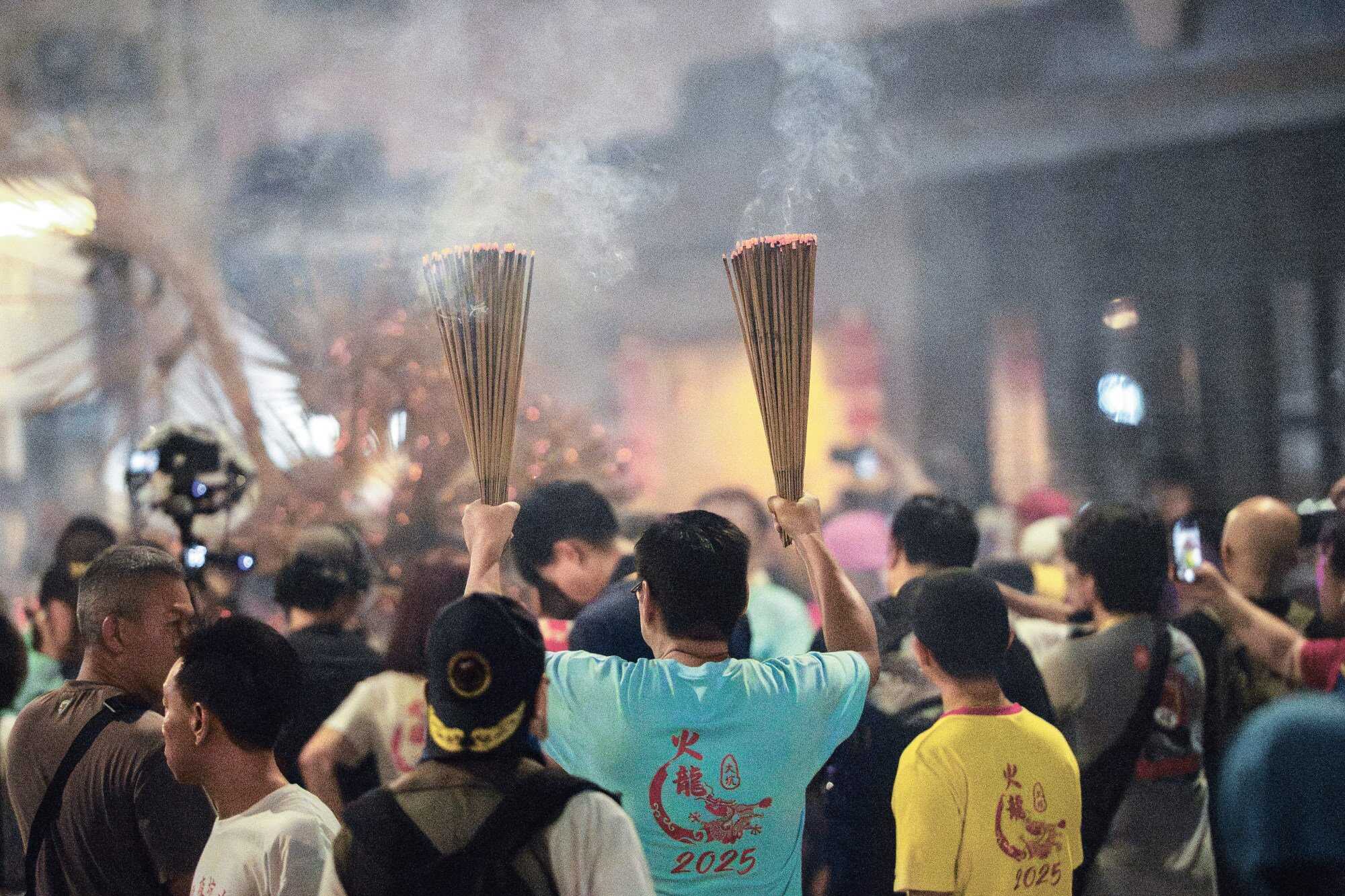 A man burns incense during the event. Photo: Huy Truong