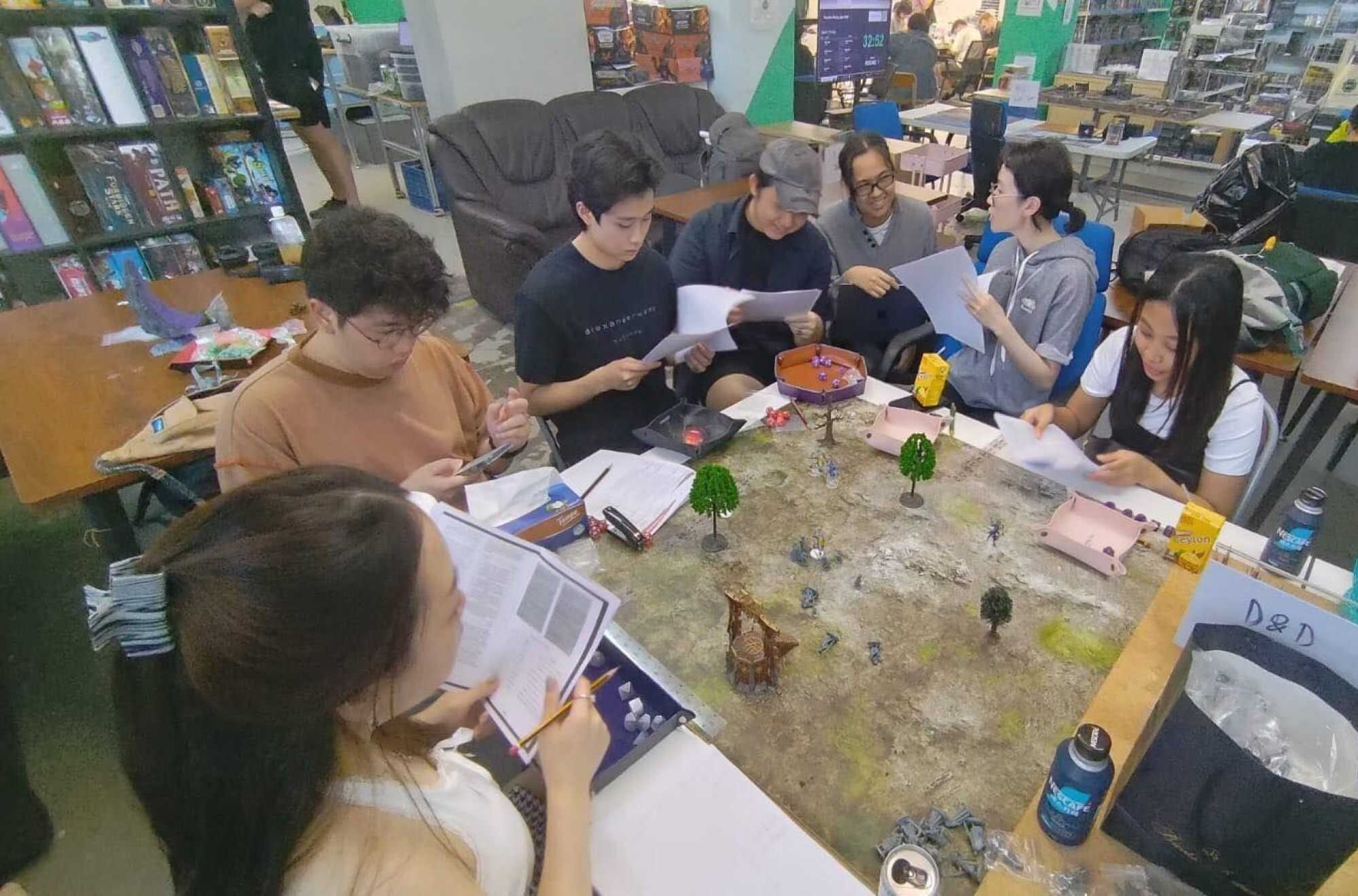 Aaron Lanorias (third from right) works with Gus Melzar Casela Geopano to lead a Dungeons & Dragons community in Hong Kong. Photo: Handout