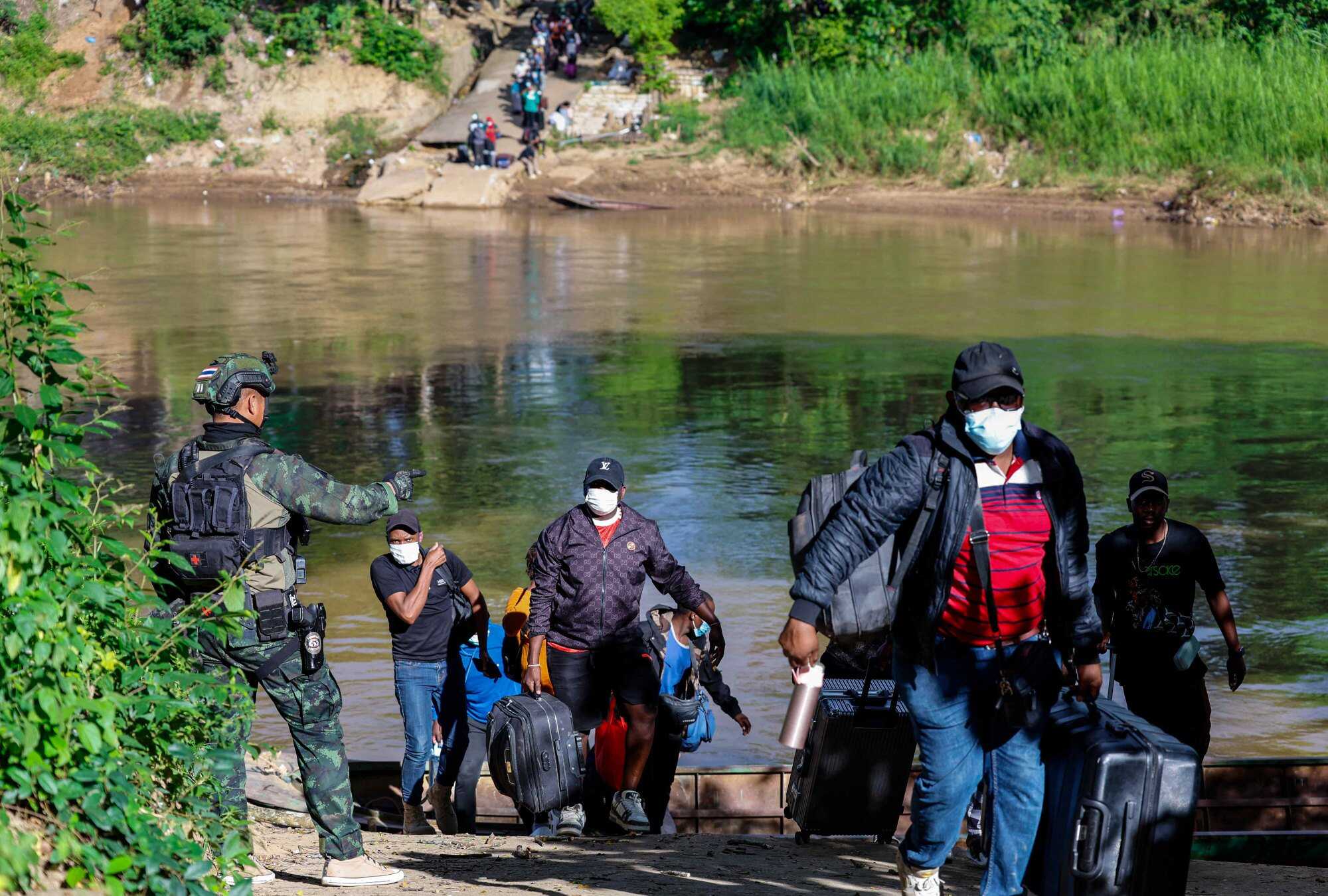 People from various countries, who were working in the KK Park compound in Myanmar, crossed into Thailand via the Moei river. Photo: AFP