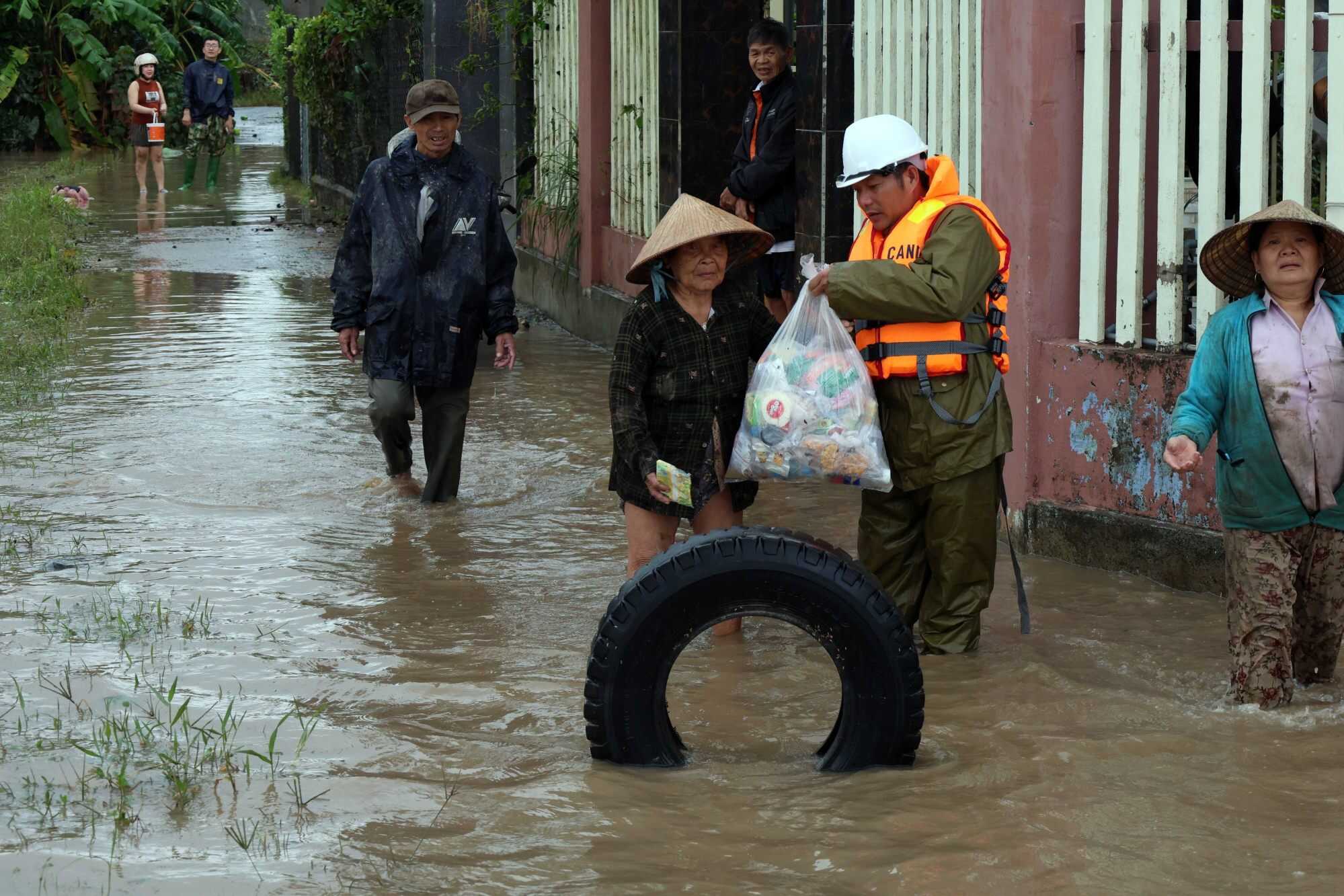 A rescuer distributes food and supplies to people in flood-hit areas of Vietnam's Dak Lak province. Photo: Handout via Xinhua