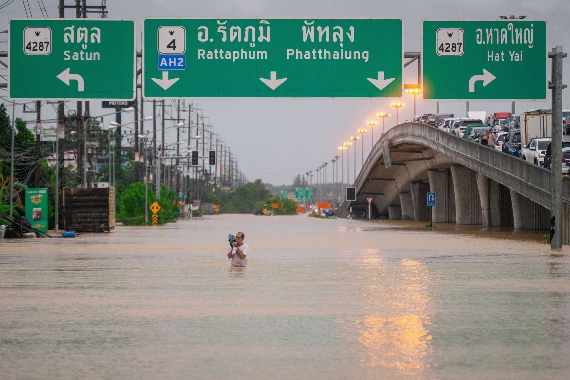 A man wades through flood waters in Hat Yai, Songkhla province. Photo: Xinhua