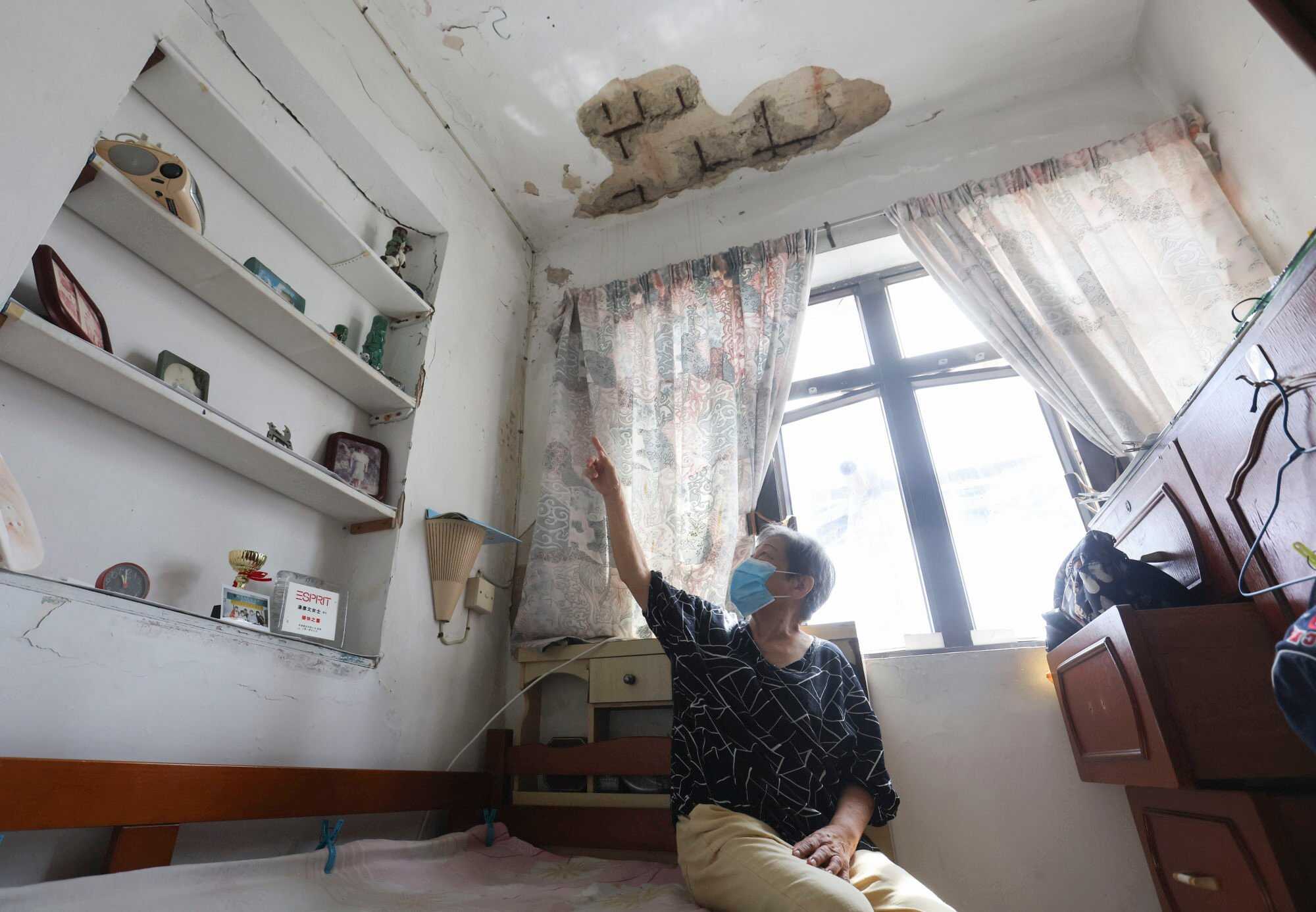 Mrs Tong points at the damaged part of her flat at Ming Lun Street in To Kwa Wan, an area part of the “five streets” redevelopment scheme planned by the URA. Photo: Edmond So