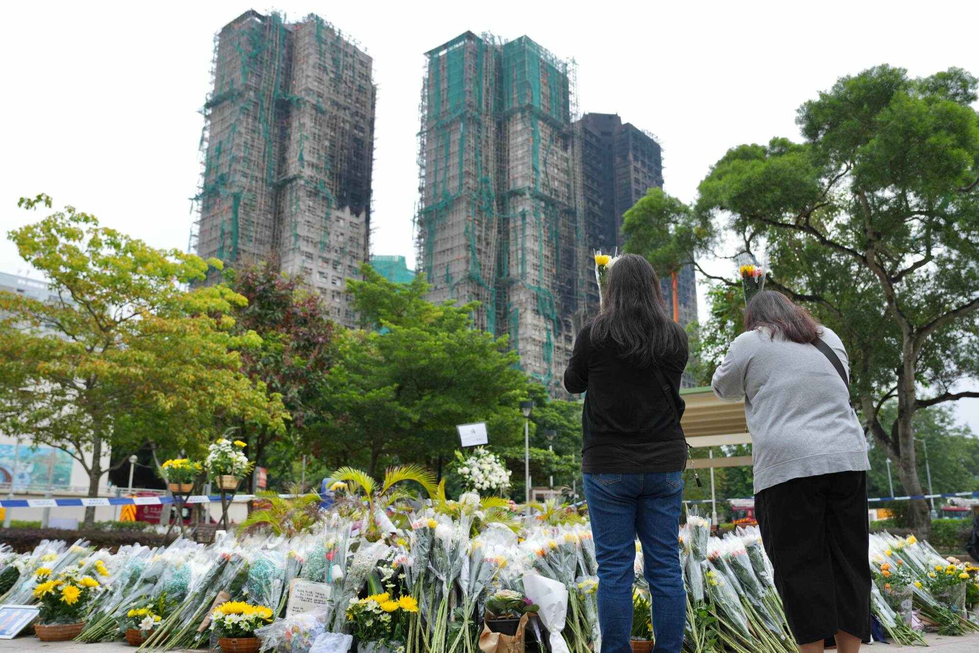 Residents pay tribute and mourn the victims of the fatal fire in Tai Po. Photo: Karma Lo