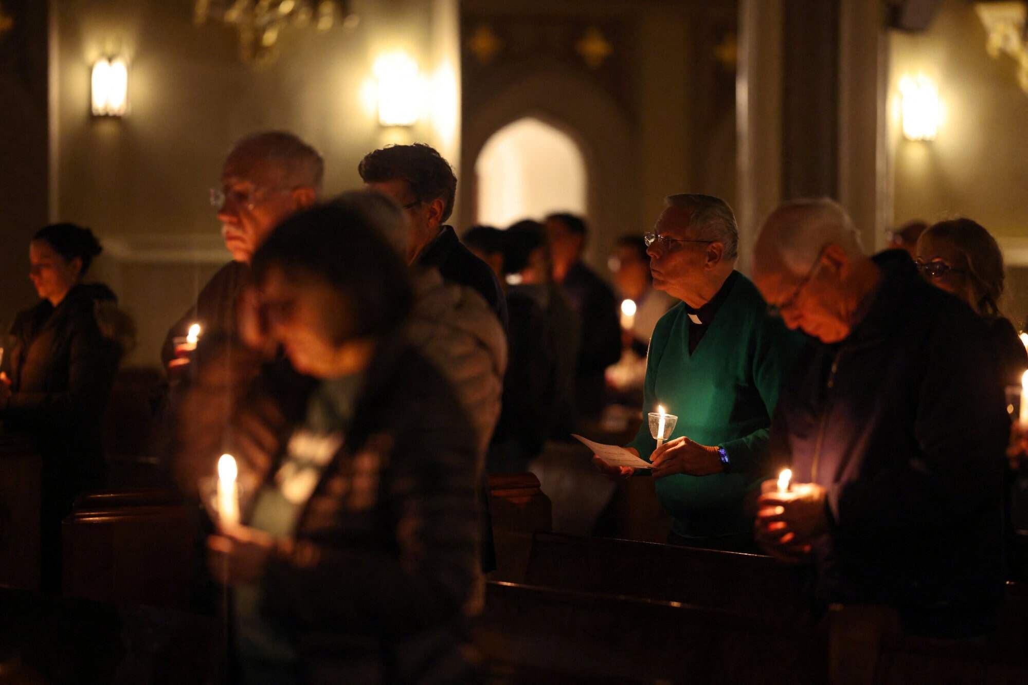 People attend a candlelight prayer vigil at the Holy Name of Jesus Catholic Church in New Orleans, Louisiana, US, for those affected by recent immigration raids during US President Donald Trump’s crackdown. Photo: Reuters
