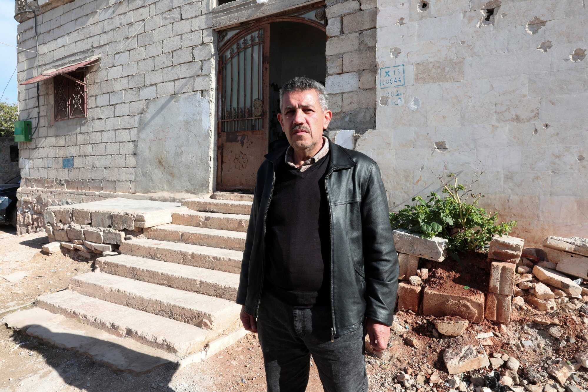 Mohammed al-Ahmed, the uncle of Ahmed al-Ahmed, stands in front of a house in the town of Nayrab in the northwestern province of Idlib, Syria. Photo: Reuters