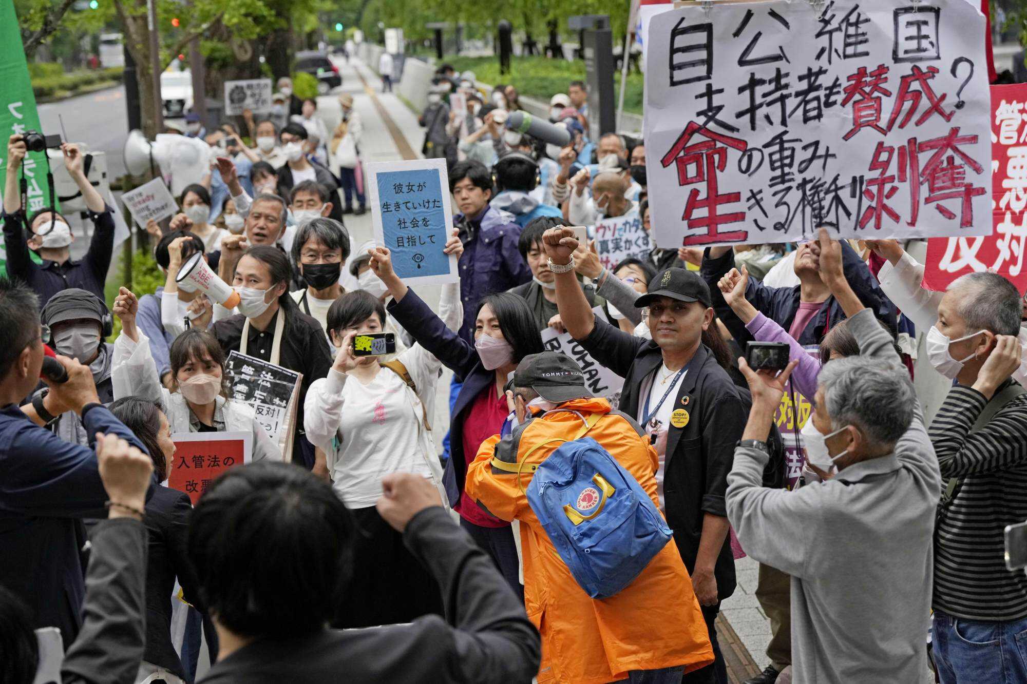 People gather in front of the Diet building in Tokyo on June 9, 2023, to protest against parliament’s passage of a bill the same day to revise an immigration and refugee law that enables authorities to deport individuals who repeatedly apply for asylum status. Photo: Kyodo