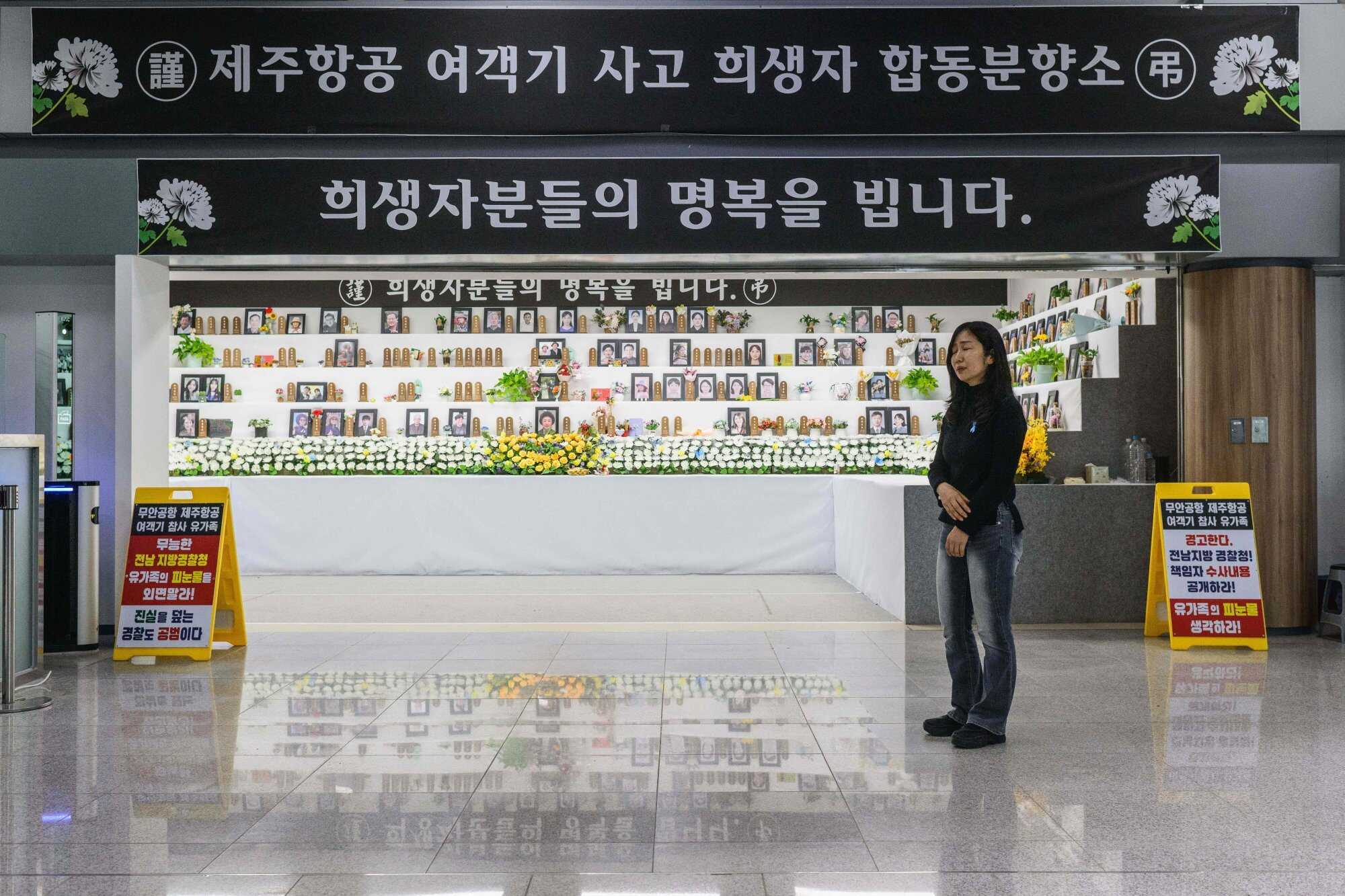 Lee Hyo-eun stands outside a memorial altar for victims, including her daughter Ye-won, in the departures hall of Muan International Airport. Photo: AFP