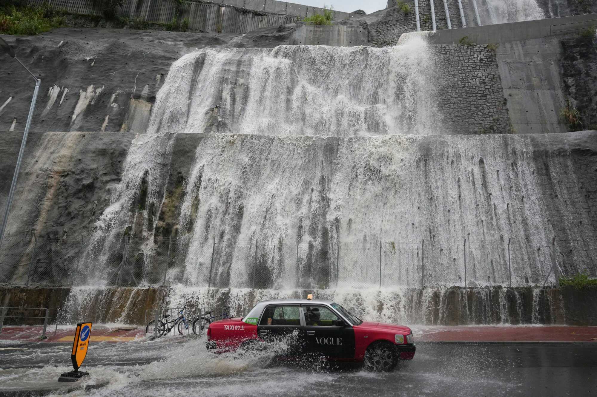 Waterfalls form along a hillside on Yiu Hing Road in Shau Kei Wan amid a black rain signal. Photo: Sam Tsang
