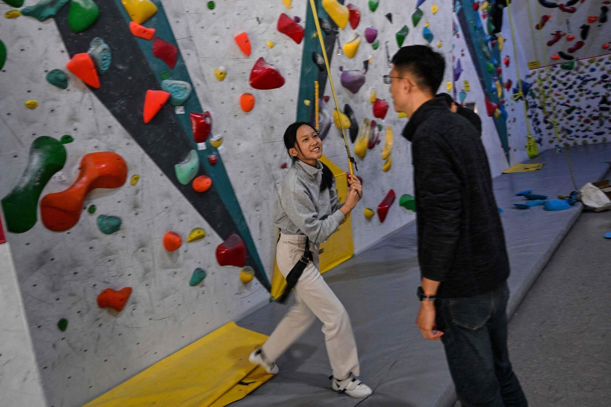 Estella with her father Shen at an indoor rock climbing venue in Shanghai. Her parents are among a small number in China who are rethinking the country’s rigorous education system. Photo: AFP
