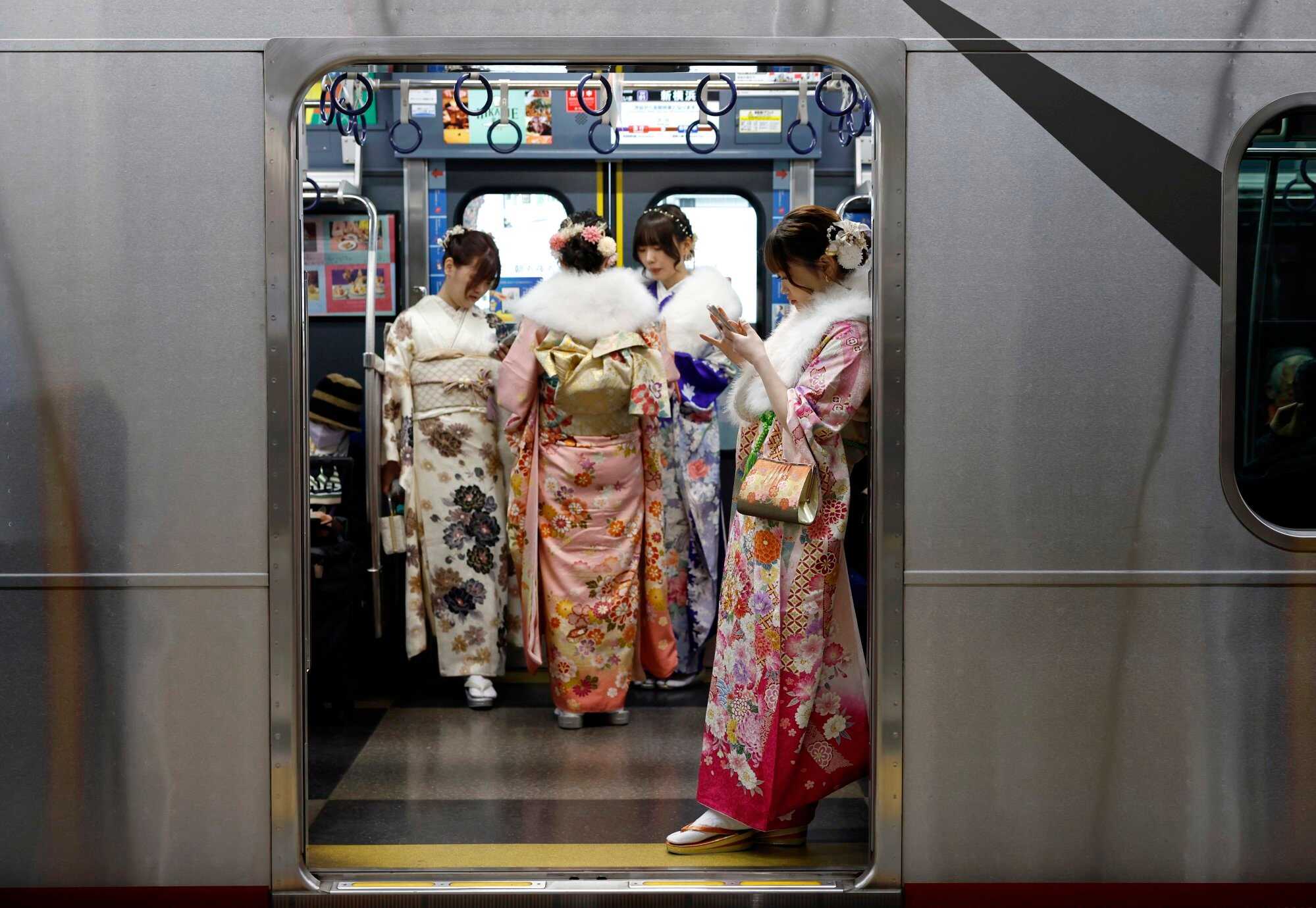 Young kimono-clad Japanese women stand in a train after attending a Coming of Age Day ceremony at Yokohama Arena. Last year, Japan recorded its lowest number of births in more than a century. Photo: EPA-EFE