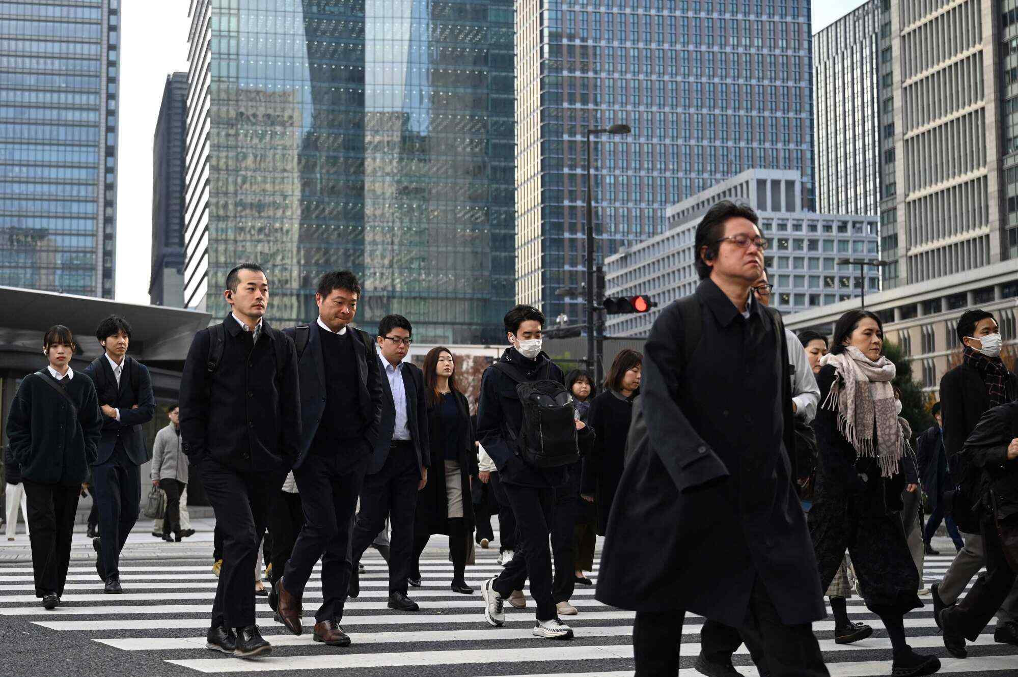 People cross a road near Tokyo Station. Dating apps are increasingly used by Japanese people to find partners. Photo: AFP