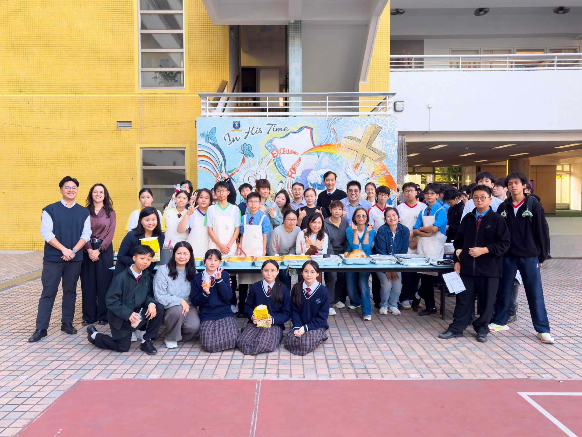 Students, teachers and volunteers gather for a photo at the school playground during their merry charity funfair. Photo: Handout