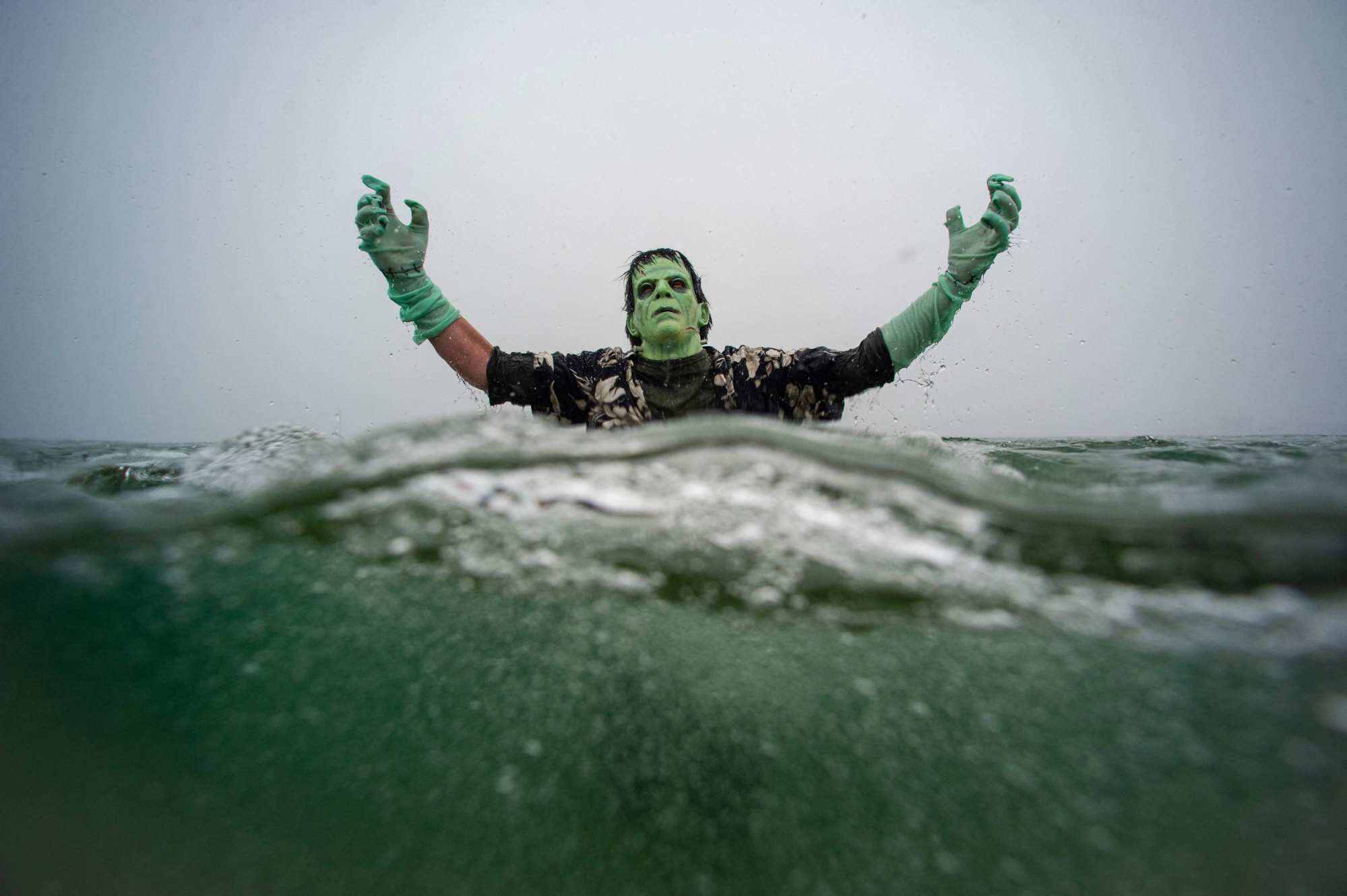 A New Year’s reveller dressed as Frankenstein’s monster plunges into the ocean on January 1, 2026, in Boston, Massachusetts. Photo: AFP