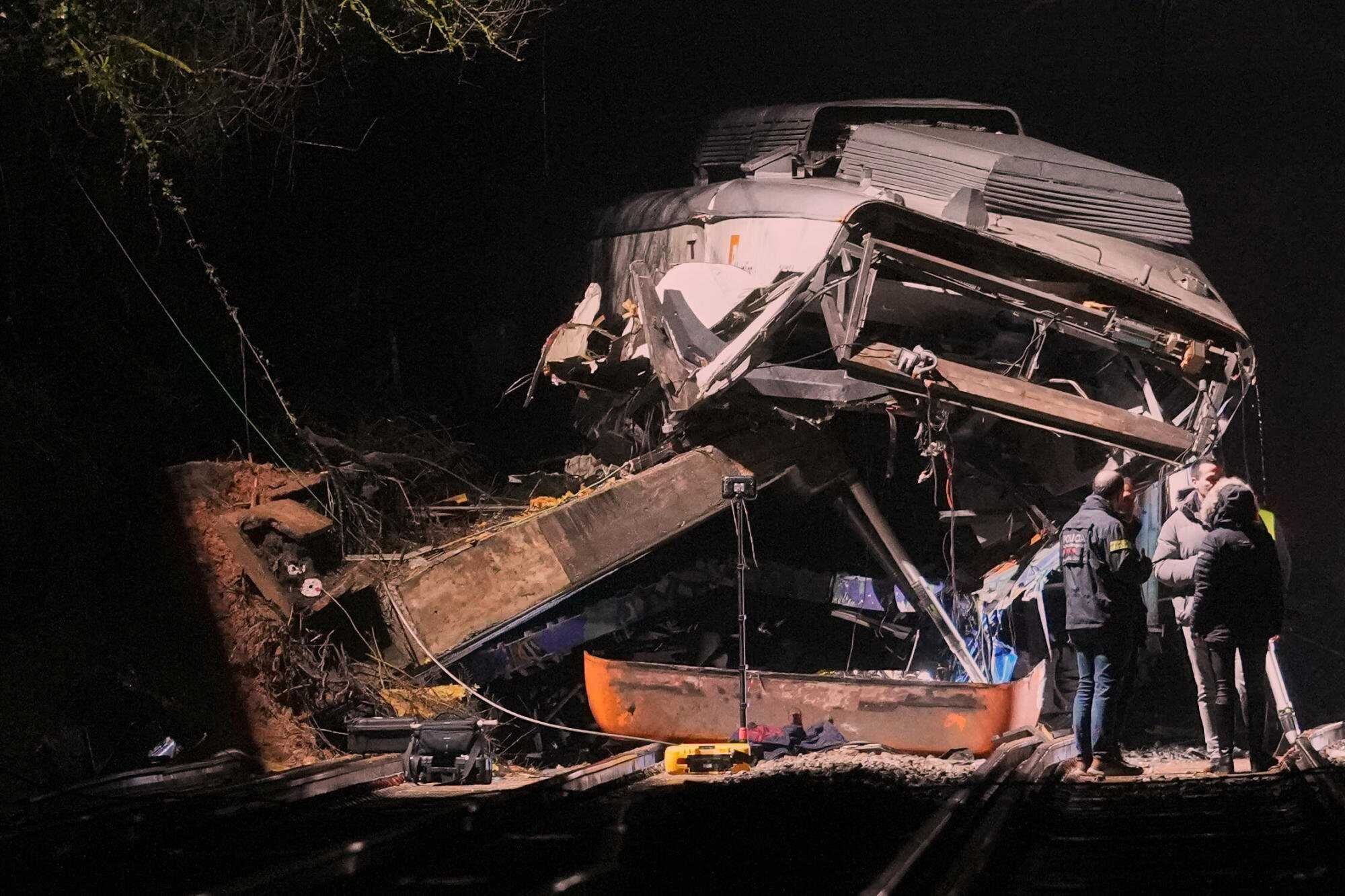 Emergency crews respond after a commuter train derailed when a retaining wall collapsed onto the tracks in Gelida. Photo: AP