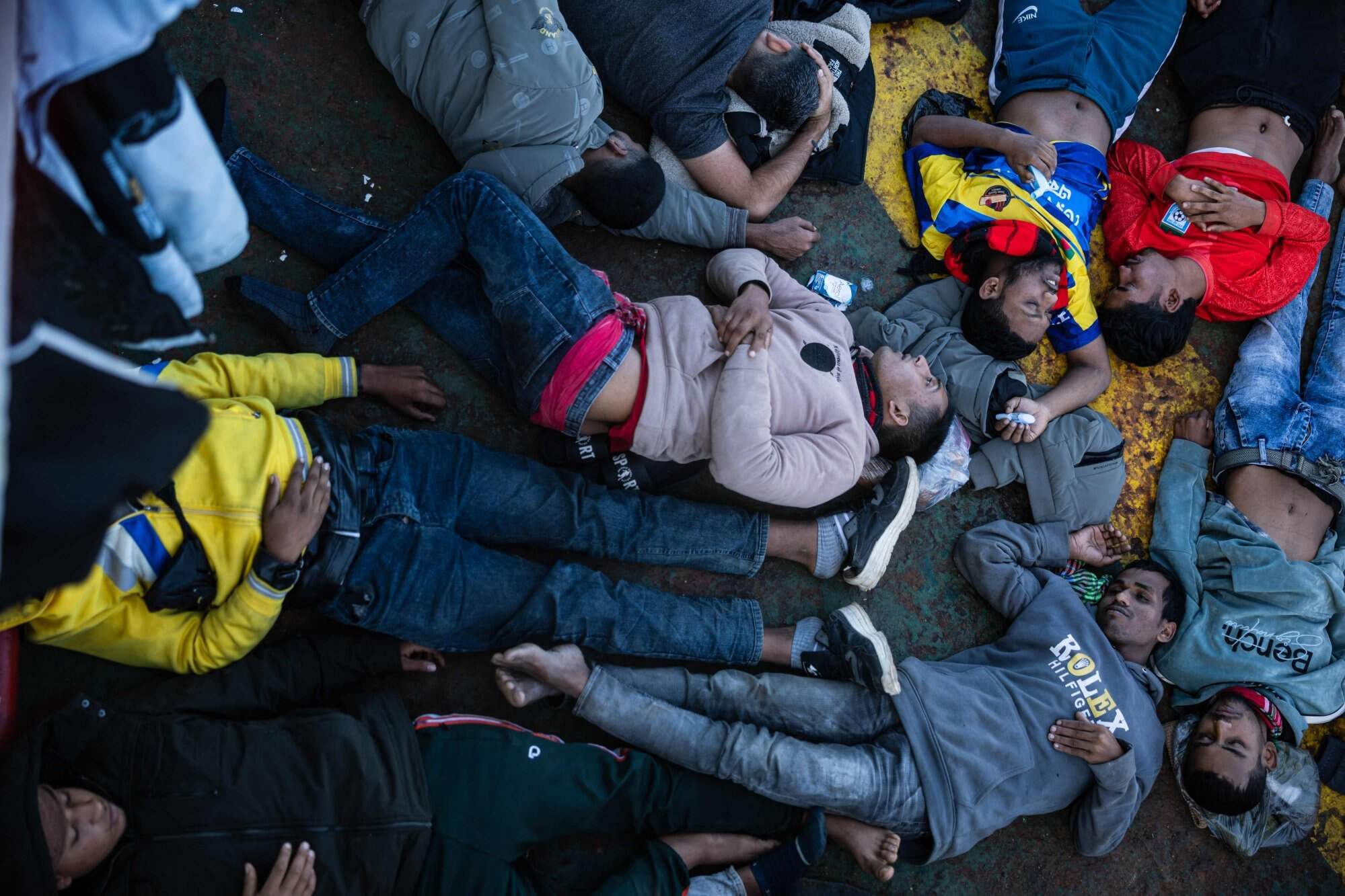 Migrants suffering from severe dehydration and seasickness lie on the floor on board the Sider, a merchant ship, in the search-and-rescue zone in international waters off the coast of Libya, on January 17, 2026. Photo: AFP