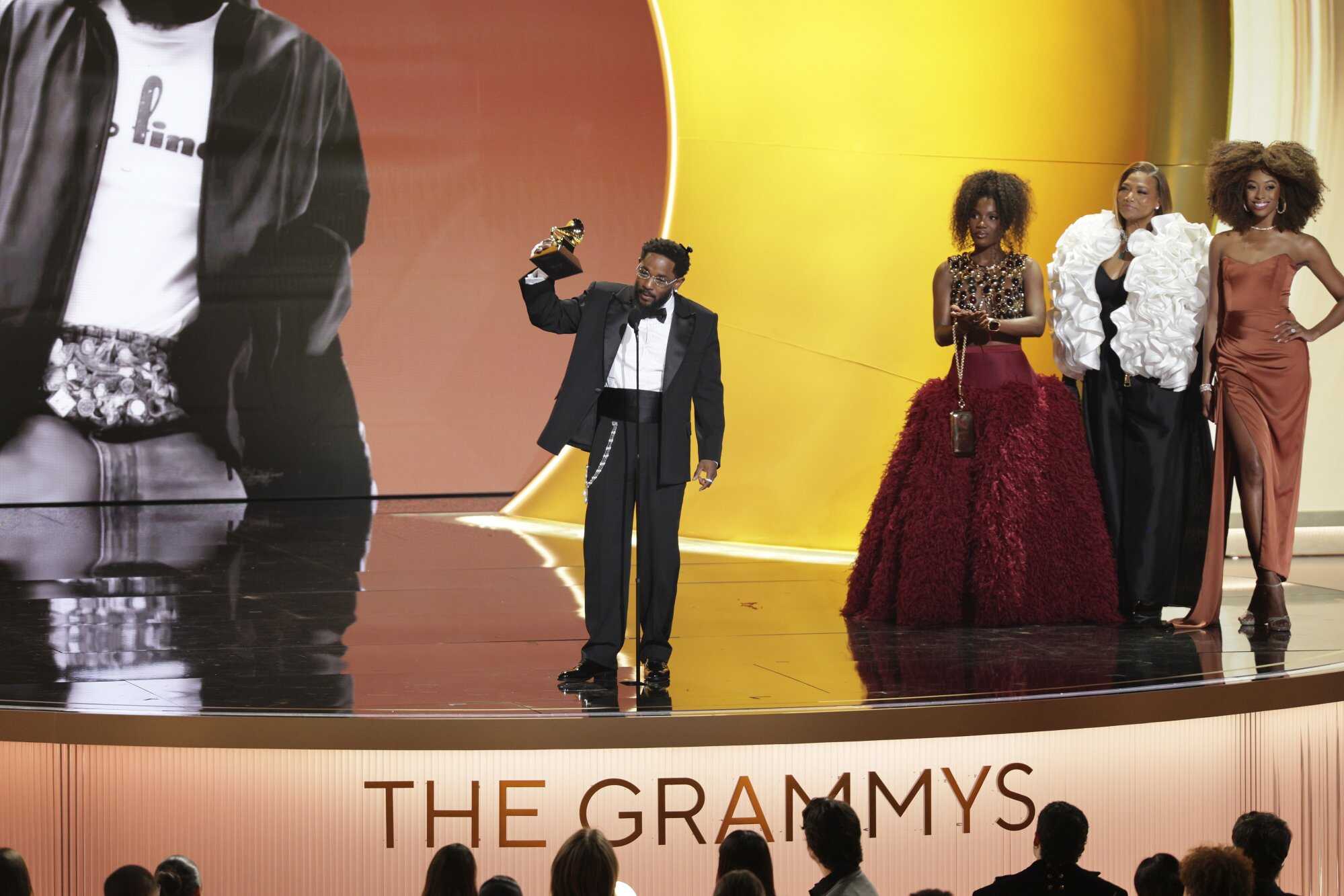 US rapper Kendrick Lamar (left) accepts the Grammy award for Best Rap Album for ‘GNX’ as presenters Queen Latifah and Doechii look on. Photo: EPA