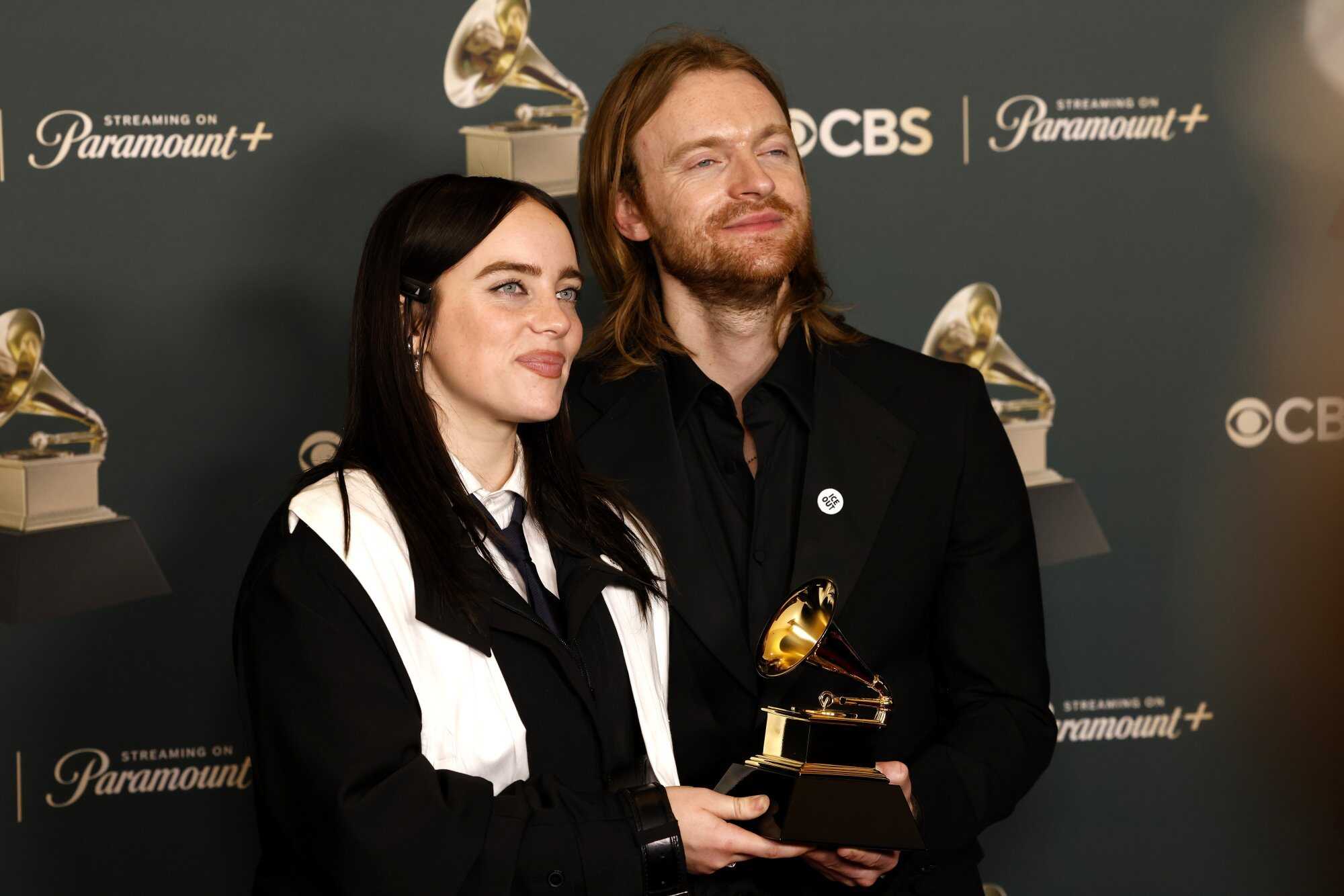 Billie Eilish and Finneas pose in the press with the award for song of the year for ‘Wildflower’. Photo: EPA