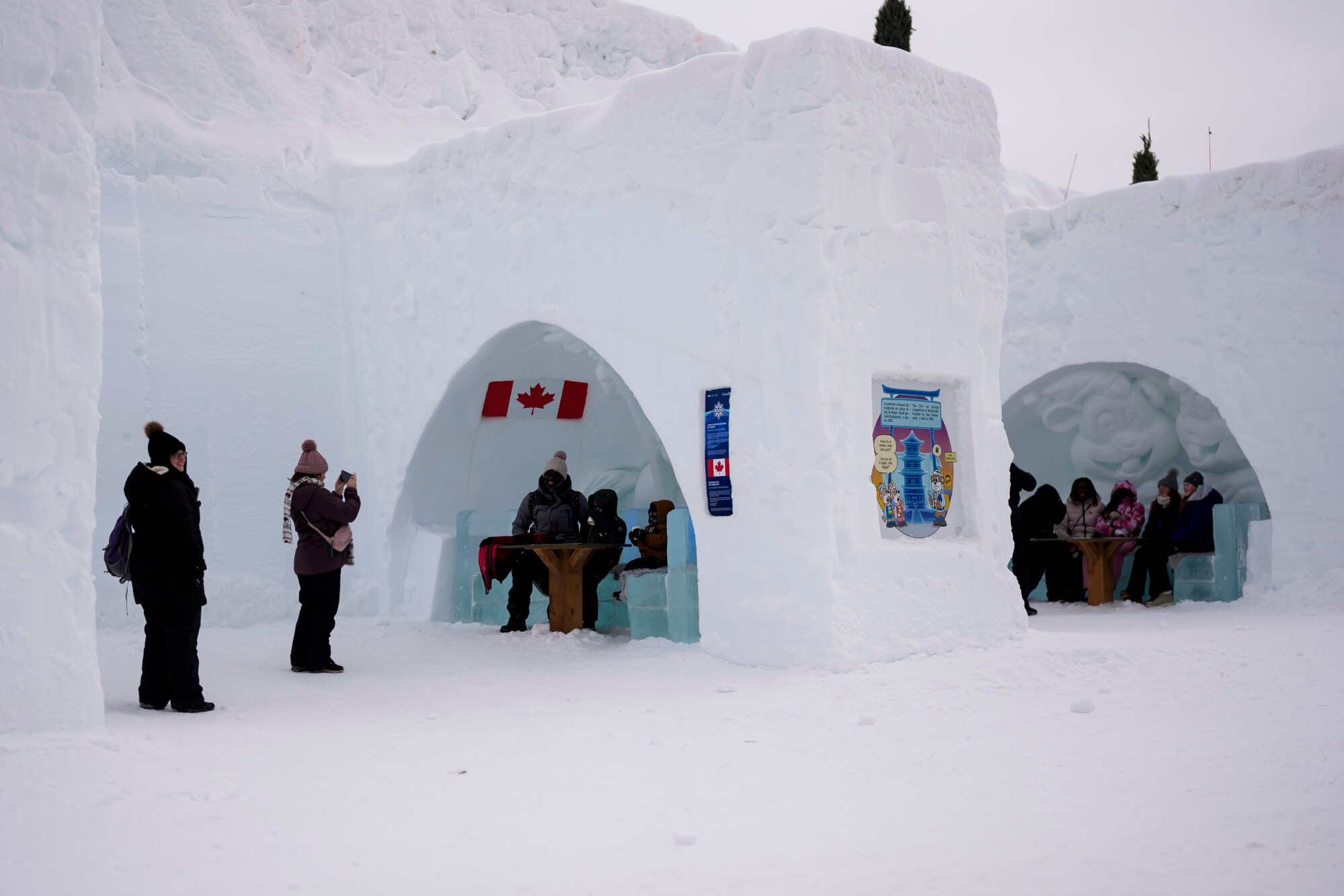 (Left, below): People pose in shapes cut into a snow wall and relax in snow lounges at Snowflake Kingdom at Jacques-Cartier Park in Gatineau, Quebec, Canada on January 31, 2026. Photos: AP