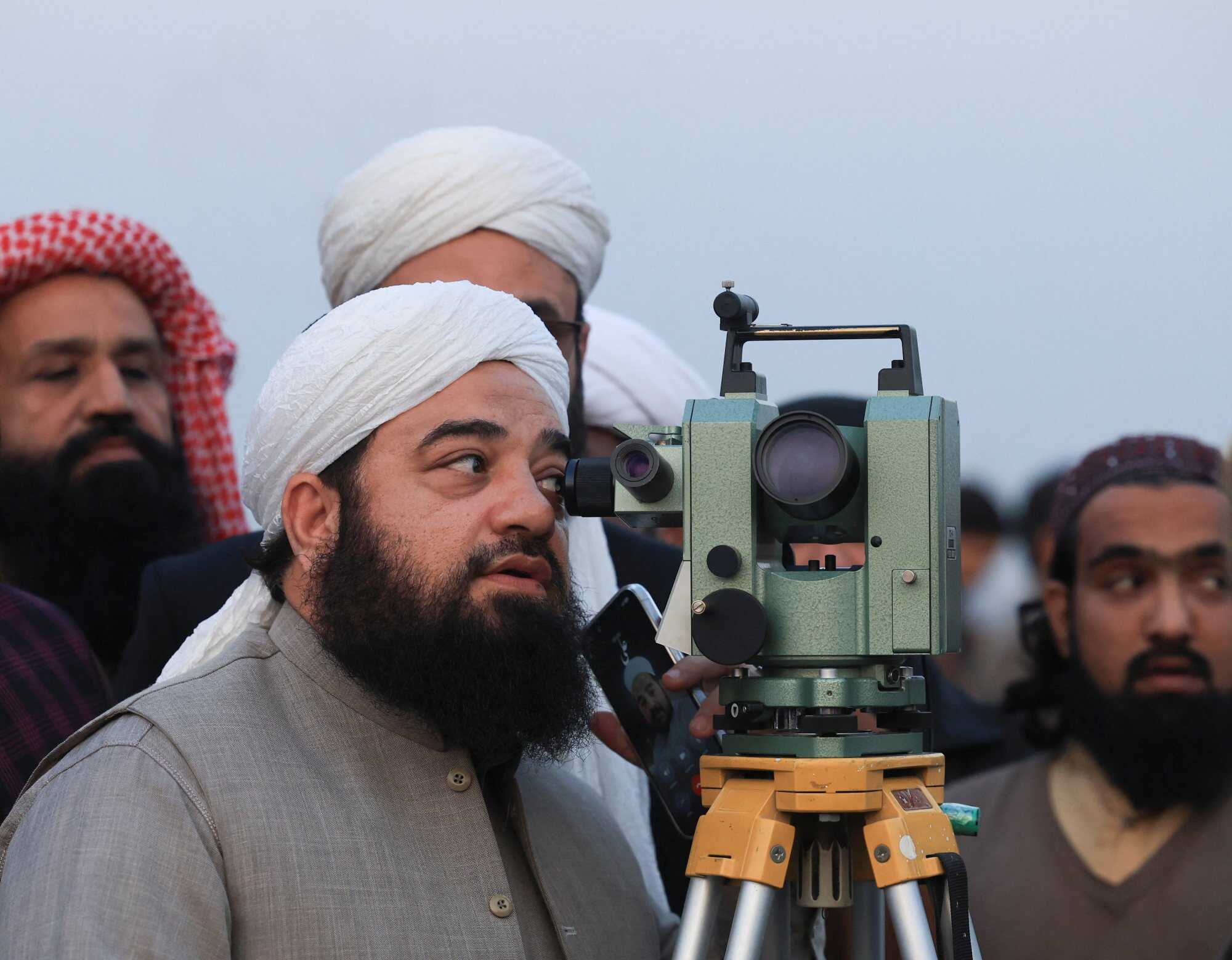 A member of the Central Ruet-e-Hilal Committee, Pakistan’s moon-sighting committee, uses a theodolite to look for the new moon that will mark the start of the holy fasting month of Ramadan, in Peshawar, Pakistan. Photo: Reuters