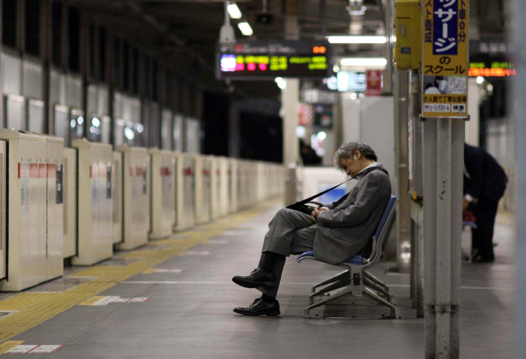 A businessman sleeping on a bench at a Tokyo train station. Japan has long had a problem synonymous with the country’s notoriously long working hours - karoshi, or death from overwork. Photo: AFP
