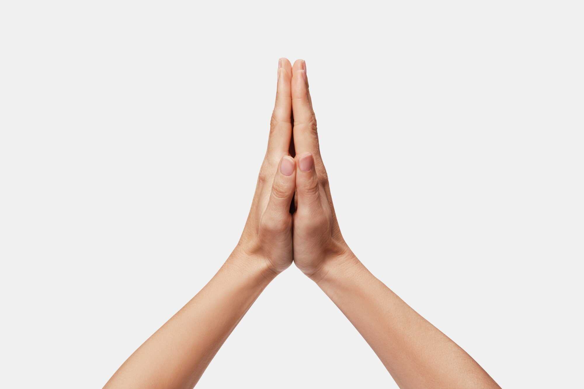 For rotations, start by pressing your palms together with your fingers and thumbs straight and pointed upwards. Photo: Shutterstock