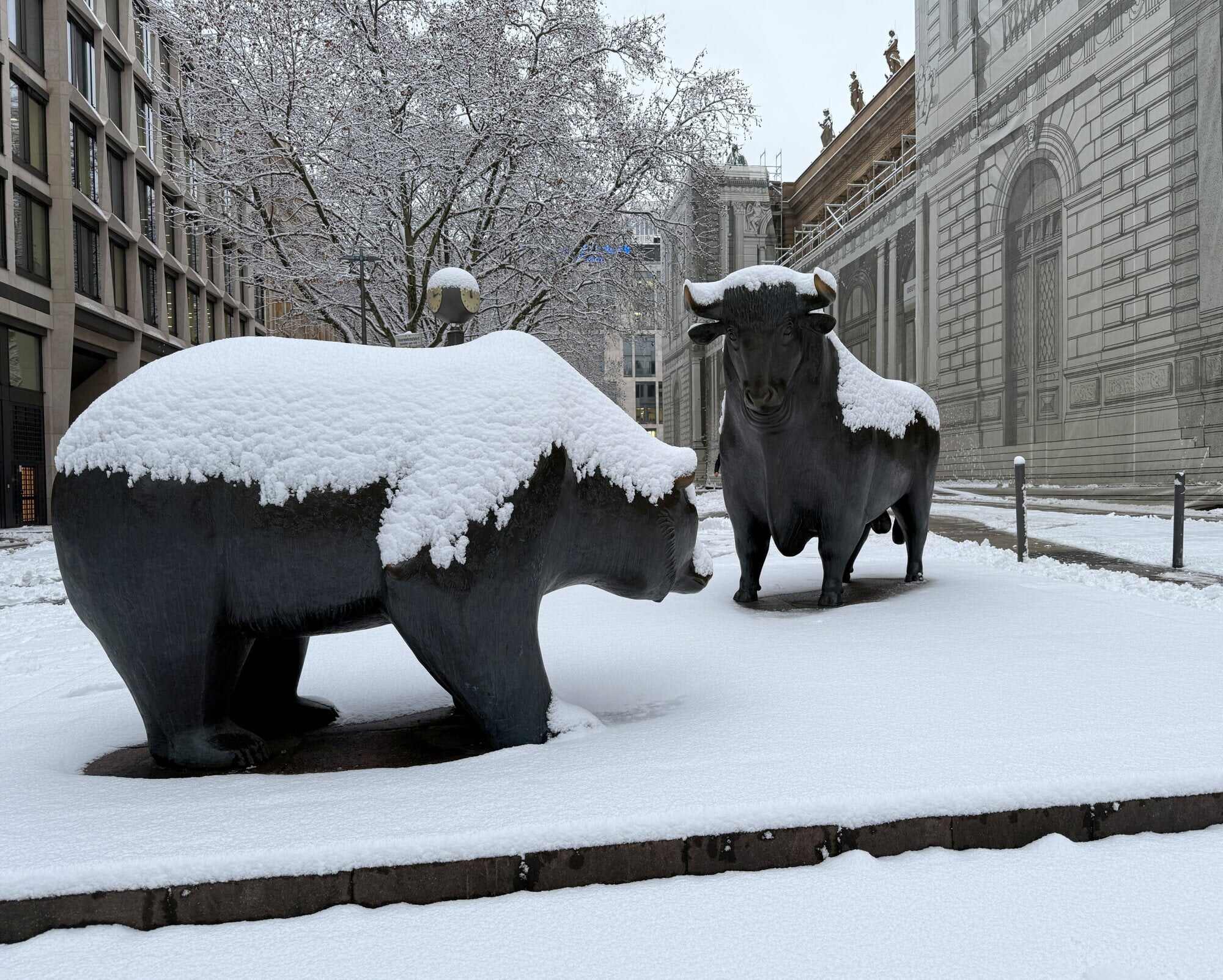 Bull and bear statues in front of the stock exchange are covered in snow after heavy snowfall in Frankfurt, Germany. Photo: Reuters